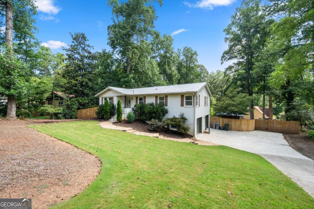 From the moment you pull up, this white brick ranch just feels like home. Step inside and you're greeted by warm hardwoods, an open-concept layout, and a light-filled living space that flows seamlessly into the dining area and bright white kitchen. The layout was made for gathering, with just the right balance of cozy and open. Watch the neighborhood deer in the morning from the brand new side deck while you sip your morning coffee. On the main level, you'll find a truly dreamy primary suite: spacious and serene, with its own en suite bathroom and a walk-in closet that checks all the boxes. Two additional bedrooms and another beautifully updated full bath round out the main floor, giving you space to grow, host, or create the perfect home office setup. The fully finished basement adds flexible square footage with brand-new LVP flooring, a full bathroom, and plenty of space to create your own media room, guest suite, gym, or playroom. But the magic doesn't stop there. Step out back and you'll find your own private oasis-a half-acre lot with a sparkling pool, room to grill, garden, and gather. It's the kind of backyard that makes every day feel like vacation. With HVAC, water heater, plumbing, electrical, and bathrooms all done in the last 4 years, all the heavy lifting has already been done. You just get to move in and enjoy. Three full bathrooms, endless possibilities, and that backyard? This one's a total gem. Amazing location and school district! Minutes to downtown Marietta (shopping, dining, foodhall and farmers market), and convenient to 75!