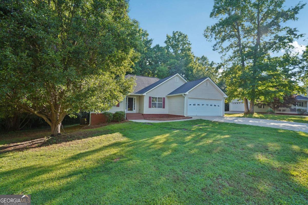 Fully Renovated Ranch in Quiet Gainesville Neighborhood! Welcome to 7210 W Field Drive - a beautifully updated 3-bedroom, 2-bath home nestled in a peaceful cul-de-sac with a large, private backyard. This turn-key property features a functional single-level layout with brand-new finishes throughout, offering both comfort and style. The open-concept living area boasts vaulted ceilings, fresh paint, and luxury vinyl plank flooring. A cozy brick fireplace adds charm and warmth to the spacious family room. The kitchen has been completely remodeled with new stainless steel appliances, quartz countertops, shaker-style cabinetry, and a modern tile backsplash. The oversized primary suite includes a walk-in closet, updated lighting, and an ensuite bath with double vanities and updated fixtures. Two additional bedrooms share a fully renovated hall bath. Enjoy relaxing or entertaining outdoors on the newly rebuilt back deck overlooking mature trees and a level yard. Key Features: * 3 Bedrooms 2 Full Bathrooms * Fully Renovated Interior * Open Concept Living & Dining * Updated Kitchen w/ Stainless Steel Appliances * Quartz Countertops & Modern Fixtures * Vaulted Ceilings & Fireplace * New LVP Flooring & Carpet * Fresh Paint Throughout * New Back Deck & Large Private Backyard * Attached 2-Car Garage * Quiet Cul-de-Sac Location Conveniently located just minutes from schools, shopping, and I-985, this home offers modern upgrades with move-in-ready convenience. Schedule your private showing today-this one won't last long!