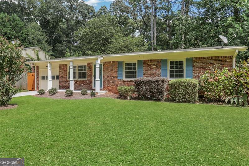Beautifully maintained four-sided brick ranch with 3 bedrooms and 2 baths situated on a large, landscaped lot in a prime location. This home features a sound system for the living room and back deck, a true walk in laundry room, solid hardwood floors, a modern kitchen with granite countertops, tiled backsplash, and stainless steel appliances. The primary suite offers an updated bath with a tiled shower and floors. Additional highlights include a professionally landscaped fenced backyard with a fire pit, a tankless water heater, a Trane HVAC system for comfort and efficiency, and an encapsulated crawlspace. Located just minutes from I-285 and Highway 20. Enjoy unbeatable convenience with close proximity to restaurants, shops, and businesses in downtown Decatur, plus just minutes from the renowned Dekalb Farmers Market. The home also offers an easy commute to major employment centers including Emory University, the CDC, and Children's Healthcare of Atlanta. Outdoor enthusiasts will love the direct access to the Stone Mountain PATH Trail-just a short walk from the front door.
