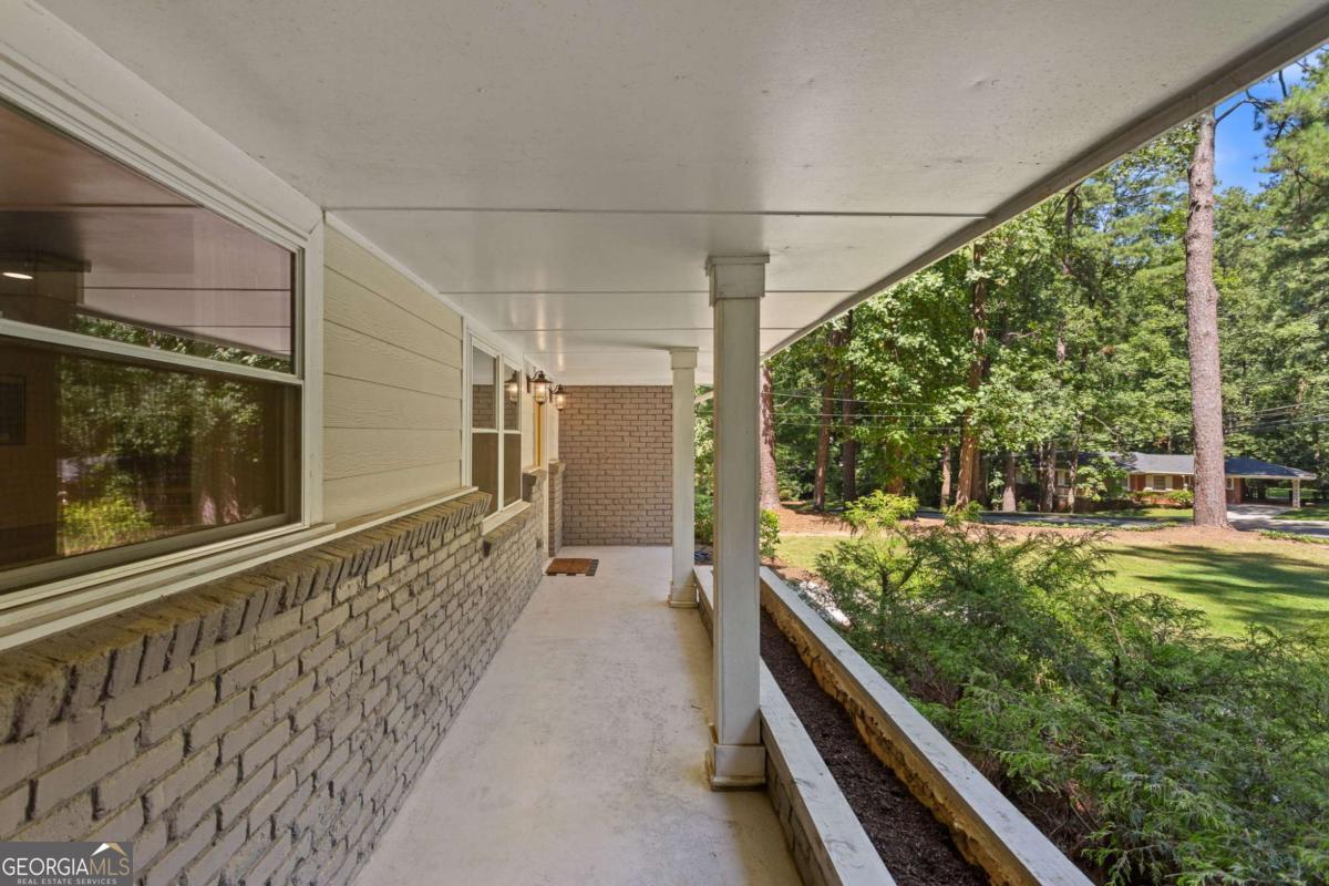 Located on a peaceful corner lot in one of Atlanta's most sought-after, walkable neighborhoods, this 4-bedroom, 2.5-bathroom gem delivers a thoughtfully renovated living space, blending timeless charm with modern updates. Step inside to discover rich hardwood floors, a striking beamed ceiling, and a shiplap accent wall that brings texture and warmth to the great room. The fully renovated kitchen is equal parts functional and fabulous, featuring sleek quartz countertops, stainless steel appliances, a wine cooler, an island with breakfast bar, and crisp cabinetry designed for the modern lifestyle. The updated bathrooms offer spa-inspired finishes, while recessed lighting throughout the home keeps everything feeling bright and airy. Out back, the screened-in porch is a true showstopper, and with a custom wall built for your mounted TV, it's the ultimate spot for entertaining, game nights, or relaxing all year long. This quiet, tree-lined neighborhood feeds into top-rated schools and offers access to a community pool with an active swim team. Optional annual membership available. All just minutes from local parks, shopping, dining, and some of Atlanta's most beloved attractions, including the Atlanta Botanical Gardens, Chattahoochee Nature Center, and the Georgia Aquarium. It's the perfect balance of peaceful living and vibrant city access.
