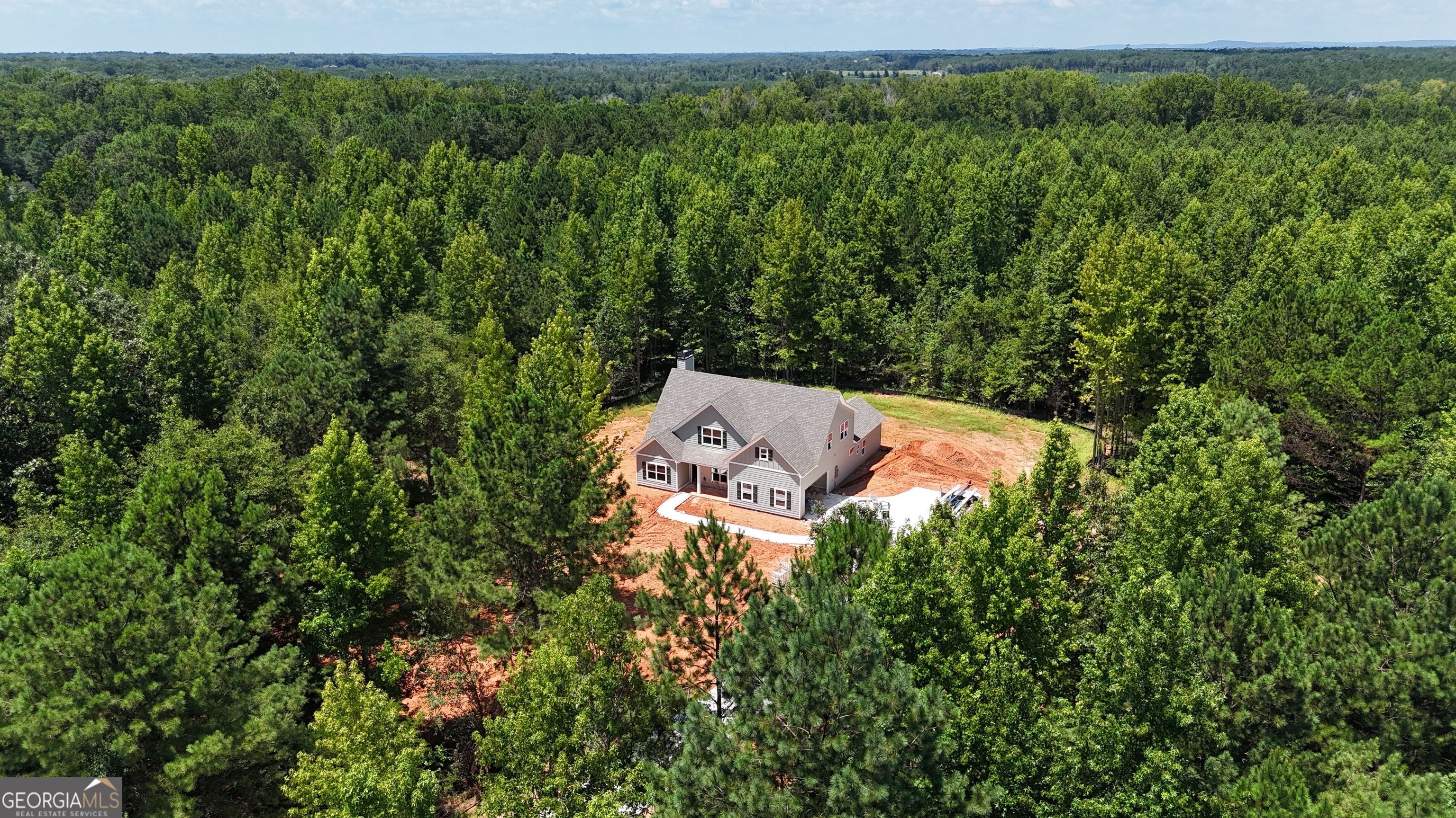 NEW CONSTRUCTION! 5 ACRES WITH NO HOA! FANTASTIC PLAN! "THE JAMESTOWN II" This beautiful 4 bedroom, 3 bath home has foyer entrance, large family room with vaulted ceiling and brick surround fireplace, open concept Kitchen and dining with luxurious designer finishes such as granite OR quartz countertops, tiled backsplash, stainless steel appliance package (wall oven, separate cooktop, vent hood, dishwasher, built-in microwave). Large master suite on the main (Vaulted Ceiling), private bath has double vanity (quartz or granite countertop), huge closet, separate soaking tub and tiled shower. But that's not all, the main floor boasts a guest suite and full bath as well as a formal dining room with an accent wall. Upstairs large bonus room plus 2 additional guest bedrooms and full bath. Estimated Completion Date is mid September 2025. Ask how you can get up to $5000 in closing cost and lender concessions when you use a preferred lender. Directions: From the Thomaston Square take Hwy 74 East - The Rock Road on left - look for signs on the left.
