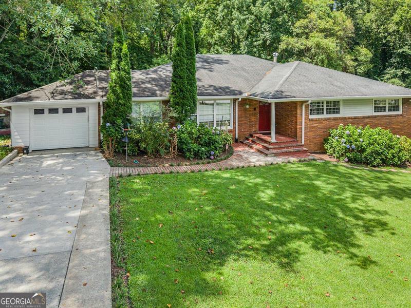Welcome to 1152 Arborvista Drive NE, Atlanta, GA 30329 Located in the sought-after Biltmore Acres neighborhood, this beautifully updated 4-bedroom, 3-bathroom brick ranch offers 3,078 square feet of stylish living on a rare, oversized lot. Just minutes from Emory University, the CDC, Toco Hills, and major highways, convenience meets comfort in one of Atlanta's most desirable areas. The custom kitchen features premium appliances, ample storage, and an open layout perfect for cooking and entertaining. Inside, you'll find hardwood floors, abundant natural light, and built-in bookshelves in the finished basement. The primary suite boasts a walk-in closet and private balcony overlooking the serene backyard. The fully finished basement includes a private in-law suite with its own entrance, full kitchen, bedroom, bathroom, family room, and is deal for multi-generational living or rental income. Outside, enjoy a lush, landscaped yard with plenty of space to garden, entertain, or add a pool. Located just 30 minutes from Hartsfield-Jackson Airport, this home offers true intown living with room to grow. Schedule your private showing today!