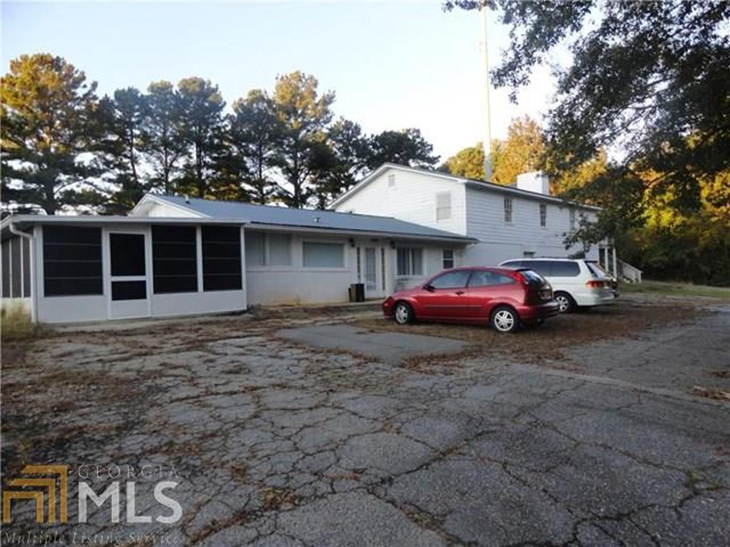 Investors -- bring ALL offers! Fixer-upper with potential! Convenient to Douglasville and 92. This is an estate sale, fixer-upper. Cellphone tower and the area inside the fenced tower does not go with the property and will be separated at closing. Again, bring all offers!