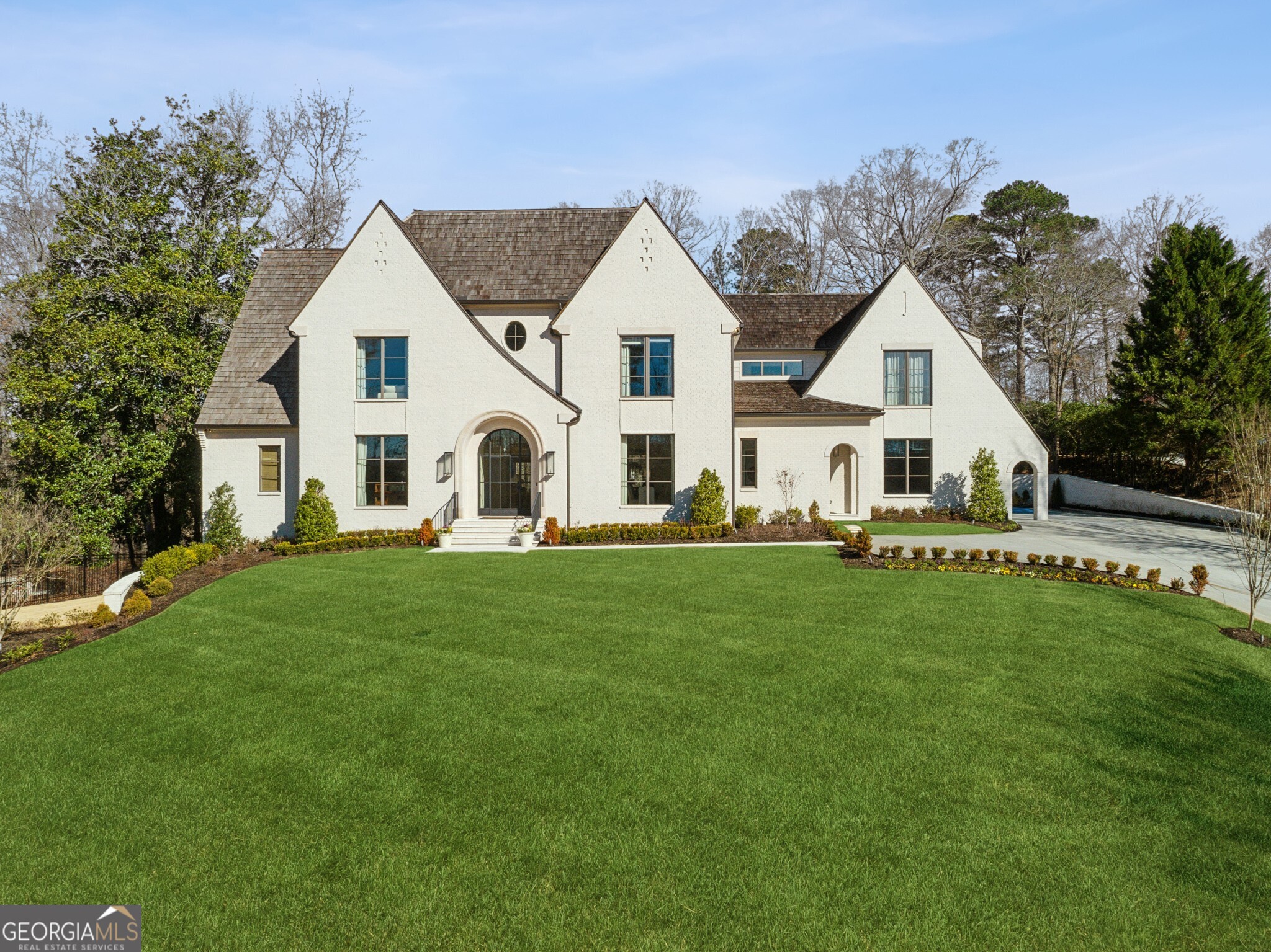 Tucked away on a quiet cul-de-sac, this one-of-a-kind newer construction home offers the perfect blend of luxury, functionality, and timeless design. Intricate architectural details found throughout the home include detailed millwork, iron windows & doors, wide plank hardwoods and custom lighting. An open, airy layout creates the perfect backdrop to accommodate everything from the flow of everyday life to entertaining on a large scale. The centerpiece of the home is the expertly crafted kitchen complete with a spacious center island, dramatic vent hood, a suite of premium appliances, walk-in wine cellar, charming breakfast nook and large scullery. The kitchen overlooks the fireside living room with stunning iron doors leading to a large, covered patio designed for year-round enjoyment complete with an outdoor fireplace, built-in grill, and TV area. The flat, fenced backyard features a sparkling pool/spa and cozy firepit area. The main-level primary suite is a true retreat, boasting a spa-like bath with dual vanities, a soaking tub, a separate shower, and two generous walk-in closets. Upstairs you'll find a versatile flex/office space along with four spacious bedrooms each feature their own en-suite bath. A fully finished basement completes this extraordinary home, complete with a large living area, golf simulator, home gym and sauna. Don't miss this rare opportunity to own a truly exceptional home in one of Buckhead's most coveted locations.