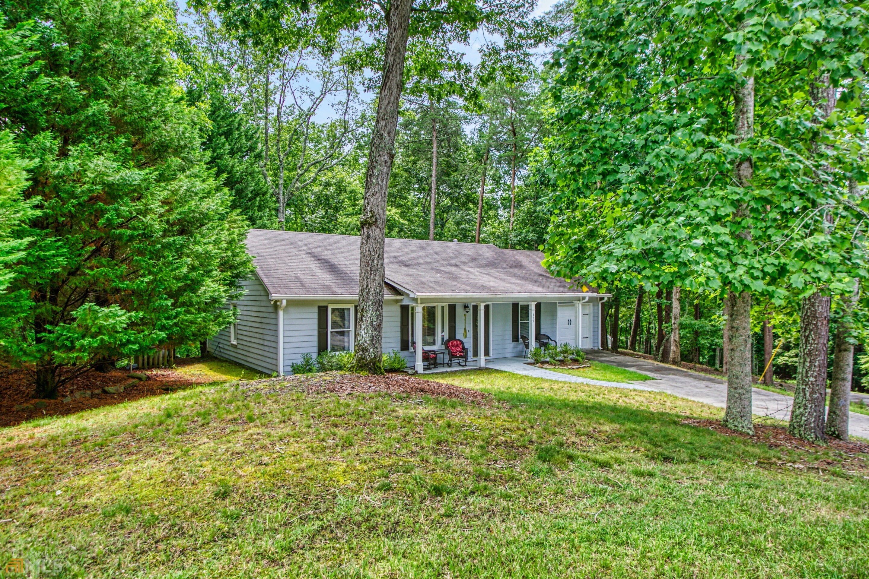 What a great and affordable weekend get away retreat or year- round residence. An easy drive from the Atlanta area located in the gated, "amenity packed "community of beautiful Lake Arrowhead. This home is in excellent condition on a wooded lot with a garage and has a large screened porch that will give you lots of additional living area. The primary bedroom is spacious as is the second bedroom. Plenty of room for overnight guests. The living room and dining room combo have an open concept feel and the kitchen has granite counter tops and updated appliances and lighting. The owners have done a lot of improvements and updates to the home including the addition of the screened porch, a washer and dryer (located in a big laundry room), a new refrigerator and water heater, stove, interior and exterior paint, granite counter tops, kitchen sink and disposal, reconfigured columns for the front porch, replaced toilets, new water pressure system and in 2021 put in a new HVAC system as well as new gutter guards for the rear gutters. The community as so much to offer starting with the picturesque 540 acre stream fed lake and marina. Additional amenities include the golf course, club house, restaurant, fishing, trails, park, playground, tennis and pickleball.
