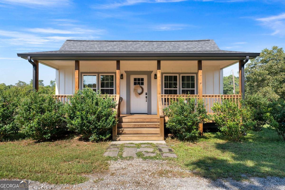 Welcome home to this custom country farmhouse on 2+ acres. You will not be disappointed as the property has been newly renovated down to the studs in 2022. This home features an open concept floorplan with laminate flooring throughout, new white cabinets in the kitchen with a custom island, granite countertops, tile backsplash, an apron sink, new ss appliance, an adjustable electric fireplace in the family room, new lighting and fixtures throughout, split bedroom plan, the master suite features a new vanity, five foot shower and soaker tub, barndoors, large laundry room off the master with access to the storm shelter/safe room. All mechanical systems are less than 3 years old which includes plumbing, electrical, hot water heater. Also, new roof with all new decking, new house wrap siding and windows have been replaced. The walls and attic has been finished with spray foam insulation for extra energy efficiency. Outside you will find a large rocking chair front porch, back patio, a detached 26x30 two car garage/carport with lighting and electrical outlets, open spaces as well as plenty of wooded privacy, and a large 33x45 pole barn. While exploring the property you will find a old spring house with a natural spring that used to serve the home as its only water source (County water has now been connected.) Septic was pimped in 2022 and inspected. Located 5-7 minutes from Hwy 75, Hwy 41 and Hwy 140. There are simply too many extras to list here. All work was done by licensed contractors and permitted. Don't miss this one.