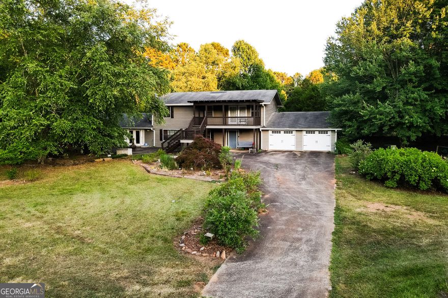 Introducing an exceptional opportunity just 3 miles from the thriving Barrow Crossing / 316 Interchange, where this expansive 20+ acre property awaits. With over 820 feet of road frontage, it's perfectly positioned for residential or multi-use development, as well as serving as a serene homestead and investment. Enjoying a mix of relatively level to gently rolling terrain, the property features partially cleared land adorned with 60% to 70% tree coverage, offering a picturesque setting and development flexibility. Strategically located amidst transformative developments, including the upcoming NGHS Medical Center just three miles away, the highly anticipated Rowen Development six miles away, and Harbins 316 approximately nine miles away, this property presents unparalleled growth potential. Additionally, included on the property is a spacious 2600+ square foot home in good condition complemented by over 2200 square feet of garage space, adding immediate value and functionality. Embrace this rare opportunity to shape the future of Walton County's landscape by contacting your agent or our team today to set up your private showing.