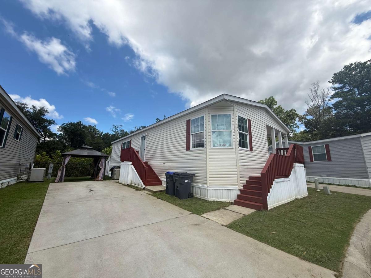 Located in a welcoming community in Lawrenceville, GA, this beautifully remodeled 2019 mobile home offers 1,456 sq. ft. of living space with 3 bedrooms and 2 full bathrooms. The home features a spacious living room, dining area, and a wide kitchen with a center island, perfect for gatherings and everyday living. Recently painted and upgraded, it is completely move-in ready. The community fee of approximately $900 per month conveniently includes the lot rent, community amenities, water, and sewer, making this an excellent opportunity to own a modern, comfortable home in one of Lawrenceville's desirable areas.