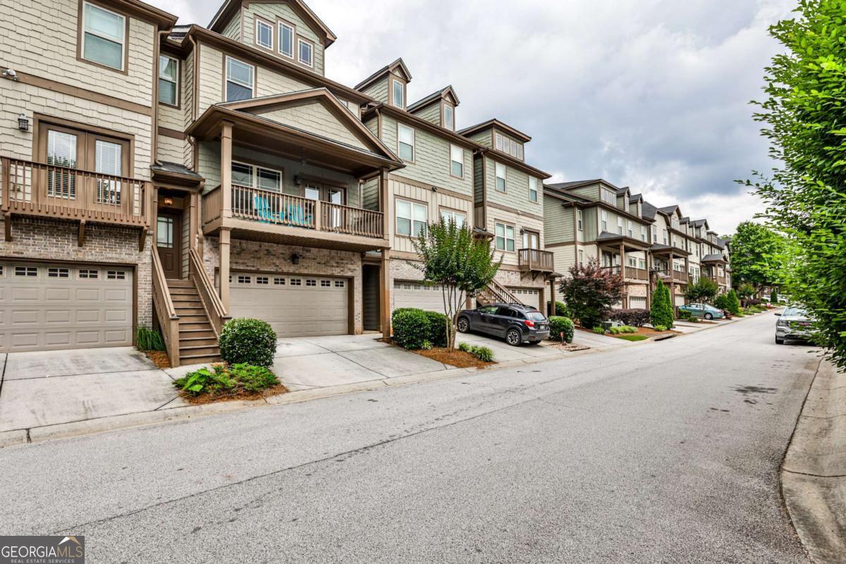The vibrant community of Avondale Estates is on the move. This wonderful townhome gives you the opportunity to be a part of all the great things happening. This three level townhome features a two car garage and private bedroom/office/studio with bath on the first level that provides access to the small back yard. The main level contains the public space. To the left at the top of the stairs is the large living room with fireplace and room for multiple sitting areas as well as the lovely front porch. Sit on the porch to enjoy your morning coffee or afternoon beverage and watch the community come to life. The large open kitchen with granite topped island, stainless steel appliances and stained cabinets shares the right side of the main level with the dining area making a fantastic entertainment zone. Just off the dining area is the large rear deck for outdoor enjoyment. The third level is home to the primary bedroom with private bath, double vanity, separate soaking tub, shower and walk-in closet. The laundry room is in the hall. The second bedroom could be a second primary bedroom with a private door to the hall bath. The community is a short walk to downtown Avondale with all it's shops and restaurants or the other direction to the Kensington Marta station.