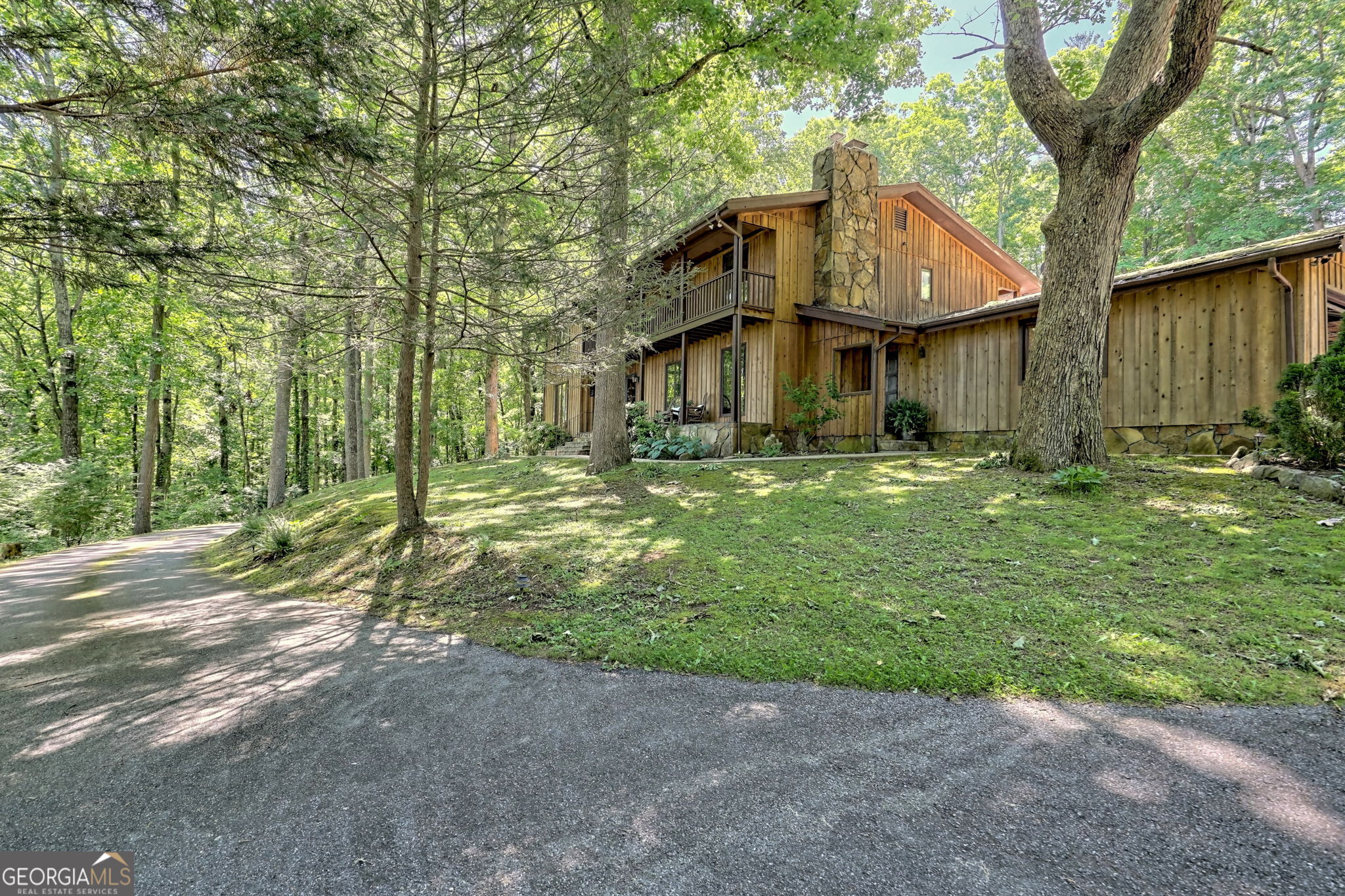 EVENT VENUE! PRIVATE, YET CONVENIENT on over 5 ACRES! PERFECT FOR ENTERTAINING! 5 bedroom, 6.5-bath home once served as a BED AND BREAKFAST, offering SPACIOUS ROOMS throughout.The huge entry FOYER. Gourmet kitchen with double ovens and breakfast room. Enjoy cozy evenings in the family room or in the large dining room and living room, each featuring its own fireplace-one propane, one wood-burning. Laundry room off kitchen in mudroom. Envision the possibilities when you add your exact tastes and personal touch to this QUALITY-built BEAUTY, The terrace level includes a large game room w/ wet bar, a bedroom, office and 2 bathrooms, (Potential for COMPLETELY SEPARATE APARTMENT). Upstairs, you'll find 4 bedrooms and 3 bathrooms arranged in 3 SEPARATE SUITES, providing ample privacy and comfort. Step outside to a fantastic in-ground pool and a large party deck, perfect for gatherings. Additionally, there is a target practice range, an attached two-car garage, and a large detached SHOP( 3 car garage) equipped with heat, a sub panel and central vacuum system. Very mild restrictions to protect your investment. This PRIVATE RETREAT sits on over 5 acres, offering peace and tranquility while being very CLOSE TO TOWN. Don't miss this opportunity to own a unique, expansive property with LAND for additional Building or EVENT Barn. (FOR VETERANS: Assumable VA loan 2.75% on large part of the purchase.)