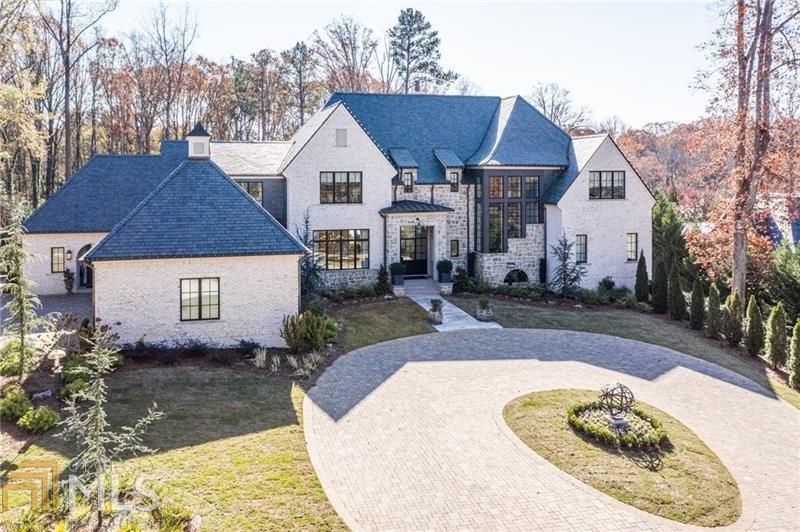 Built in 2018, this magnificent estate home is undoubtedly one of the most exceptional properties to hit the market in recent years. Beautifully sited on a very private 2.4+/- acre lot, the current owners have customized every detail to create a warm and inviting space designed with entertaining in mind. Amenities include a luxurious main level owner's suite with dual custom walk-in closets, elevator access to all levels, a flat walk-out yard with pool and spa, whole house generator & water filtration system, fully finished terrace level with amazing wine cellar & tasting room, media room, yoga/sauna room, and a home gym rivaling any professional sports facility. A spacious terrace overlooking the pool includes an outdoor kitchen, woodburning fireplace plus a seating area with remote screens and shades.  Incredible architectural details throughout include a slate roof, 14 ft ceilings, iron doors & windows, copper gutters and gas lanterns. Ideal location convenient to private schools, shopping, restaurants, and the interstate.  This special home presents the very best quality, style, and design -- every detail is perfection! Truly a rare opportunity for you to have it all.