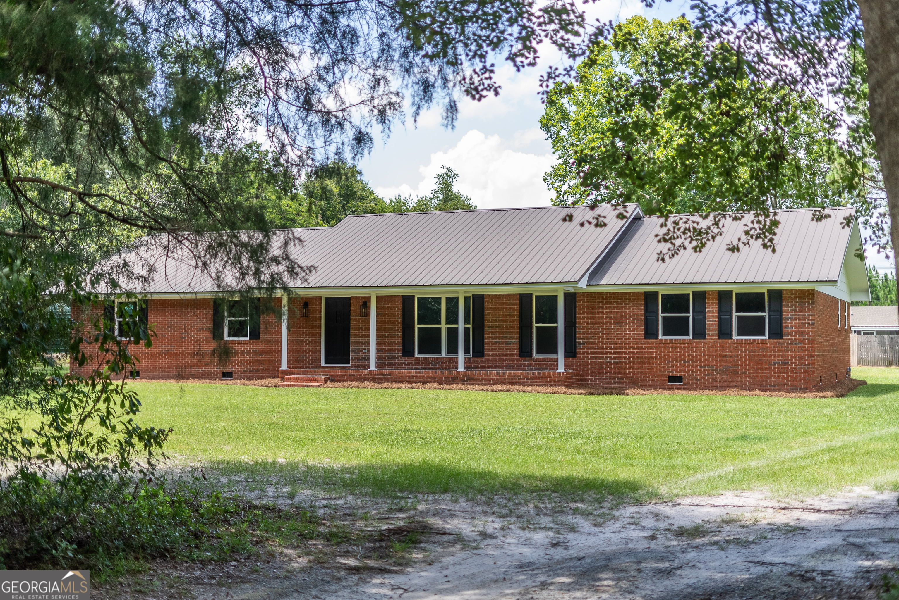 Spacious & Updated 4 Bed Brick Home on 1 Acre - Hoboken School District. This beautifully updated 4-bedroom, 3-bath brick home offers 2,464 square feet of comfortable living on a full acre lot. Located in Brantley County it's zoned for the highly sought-after Hoboken Elementary School. Inside, you'll find two large living spaces-perfect for entertaining, relaxing, or creating a playroom or home office-as well as a dedicated laundry room for added convenience. The home has been fully updated and features a newer metal roof and HVAC system, both less than 5 years old. Enjoy ample parking and storage with an attached carport and an additional RV carport. The private drive leads to a spacious yard offering plenty of room to spread out, garden, or host gatherings. Ideally situated between Hoboken, Waycross, and Blackshear, this home delivers the peace of country living with easy access to everything you need. Seller Holds GA real estate license.