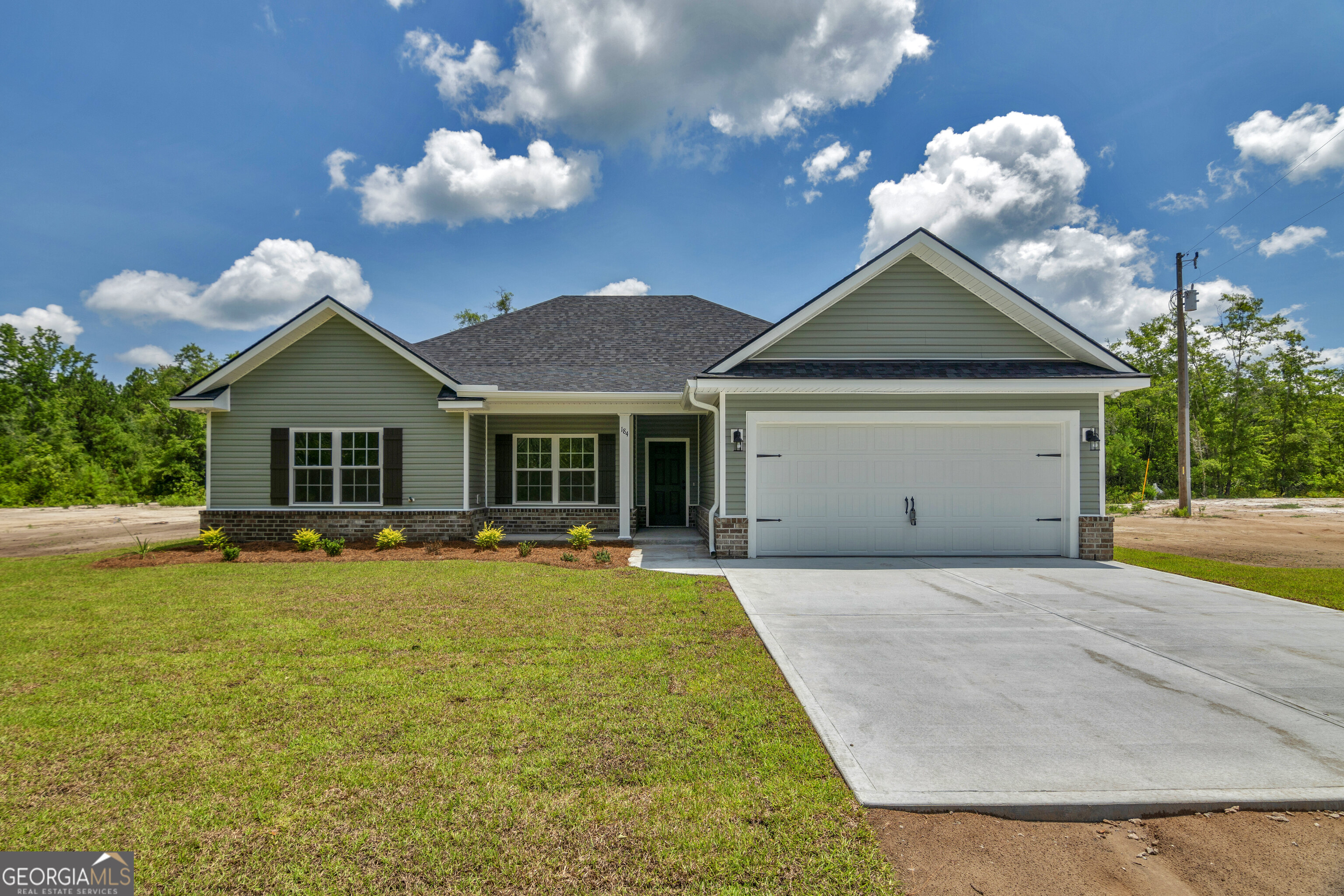 Welcome to your dream home with acreage in Long County! This stunning new construction offers 4 spacious bedrooms and 2 full bathrooms, all nestled on a generous 1.75-acre cul-de-sac lot-perfect for privacy, outdoor living, or future expansion. The builder is offering up to 10k towards closing costs or interest rate buy downs! Step inside to find an open-concept layout filled with natural light, modern finishes, and high-quality craftsmanship throughout. The kitchen features quartz countertops, custom cabinetry, stainless steel appliances, and ample countertop space-ideal for both cooking and entertaining. The primary suite includes a large en-suite bath with double vanities, a soaker tub, large walk-in shower, and walk in closet! Enjoy peaceful mornings on the covered front porch or host gatherings on the back patio overlooking your backyard. No HOA. The possibilities are endless-build a workshop, add a pool, or just soak in the wide-open views. Located just minutes from local amenities and schools, and a short commute to Fort Stewart or Brunswick! This home combines the tranquility of country living with everyday convenience. Schedule your showing today-this one won't last long!