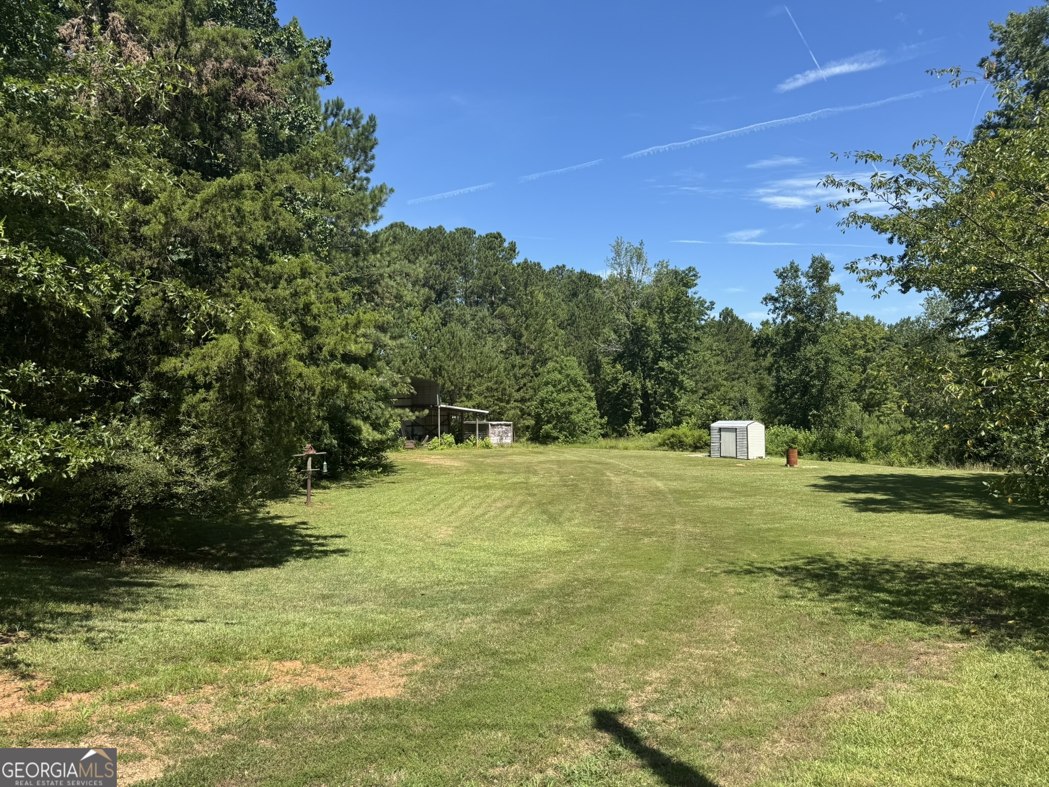 3.65 Acre Lot with Gorgeous Trees! Hurry to see this great opportunity before it's snapped up! Lots of beautiful homes being built nearby. Great potential for homesite including ones that are private, perfect for a basement, nestled in the trees or a leveled site. 20x40 "barn" was used for heavy equipment but also has tin to complete the front if desired. Sea container to remain, great for covered storage. Conveniently located within minutes of I-75, shopping, restaurants, etc.