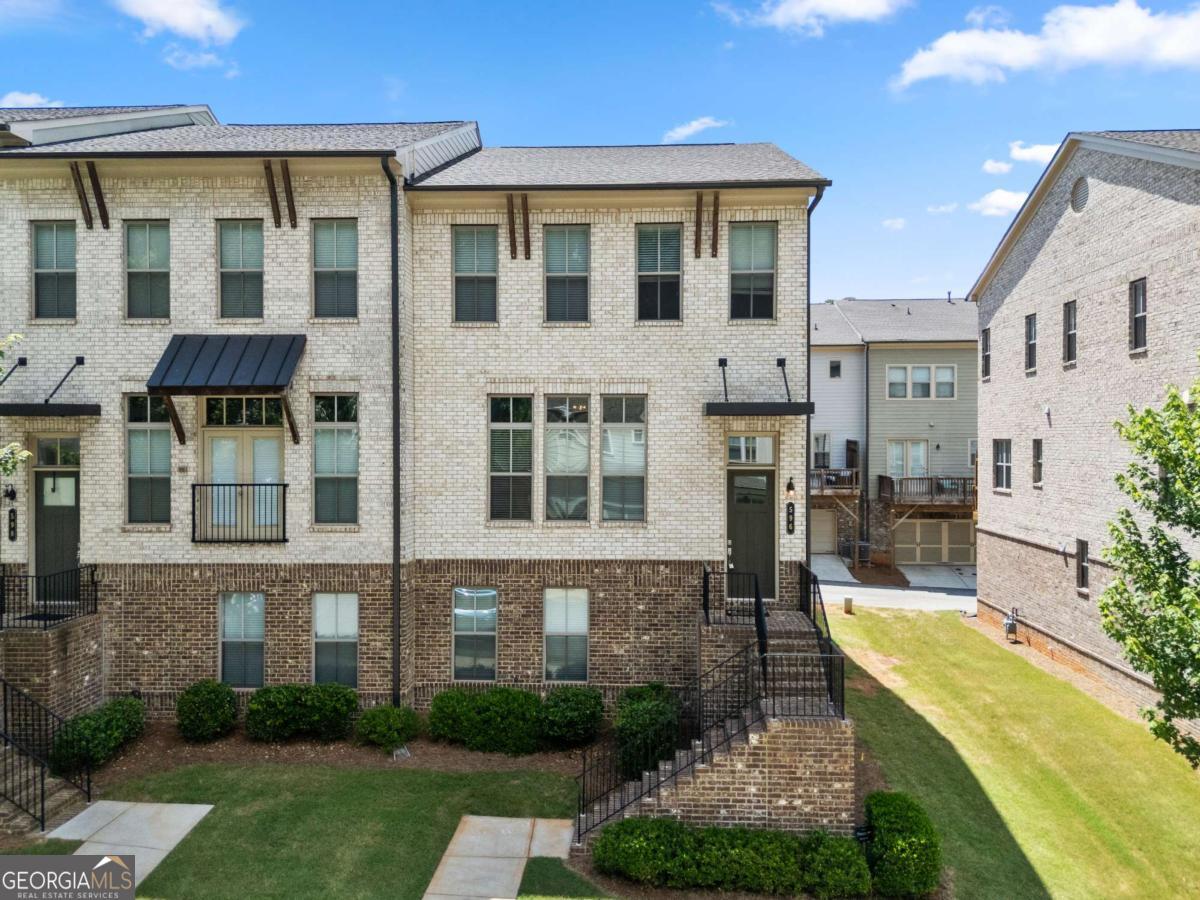 One of the largest floor plan featured four-bedroom three full bath end-unit townhome located in the highly sought-after Avondale Hills community. Freshly painted whole and garage. 10-foot ceilings on the main level and hardwood floors throughout, No Carpet. Enjoy a chef-style kitchen with generous island, and a walk-in pantry for effortless organization and an open-concept layout that flows into the dining area and onto the private deck. Expansive living room with oversized windows, streaming sunlight, and a charming gas fireplace as the focal point, pre-wired and ready for your TV setup. Upstairs, the bright primary suite offers a double vanity bathroom, large shower, and a walk-in closet. Two additional bedrooms, a full bath, and a spacious laundry room complete this level. Private bedroom suite located on the first level, includes another massive walk-in closet, and private full bath. This home is located just outside Historic Avondale Estates, only a couple of miles from Downtown Decatur, and a short drive to the Atlanta Beltline, Midtown, and Downtown Atlanta. Enjoy nearby shopping, restaurants, Publix, Your DeKalb Farmer's Market, and Marta is within walking distance.