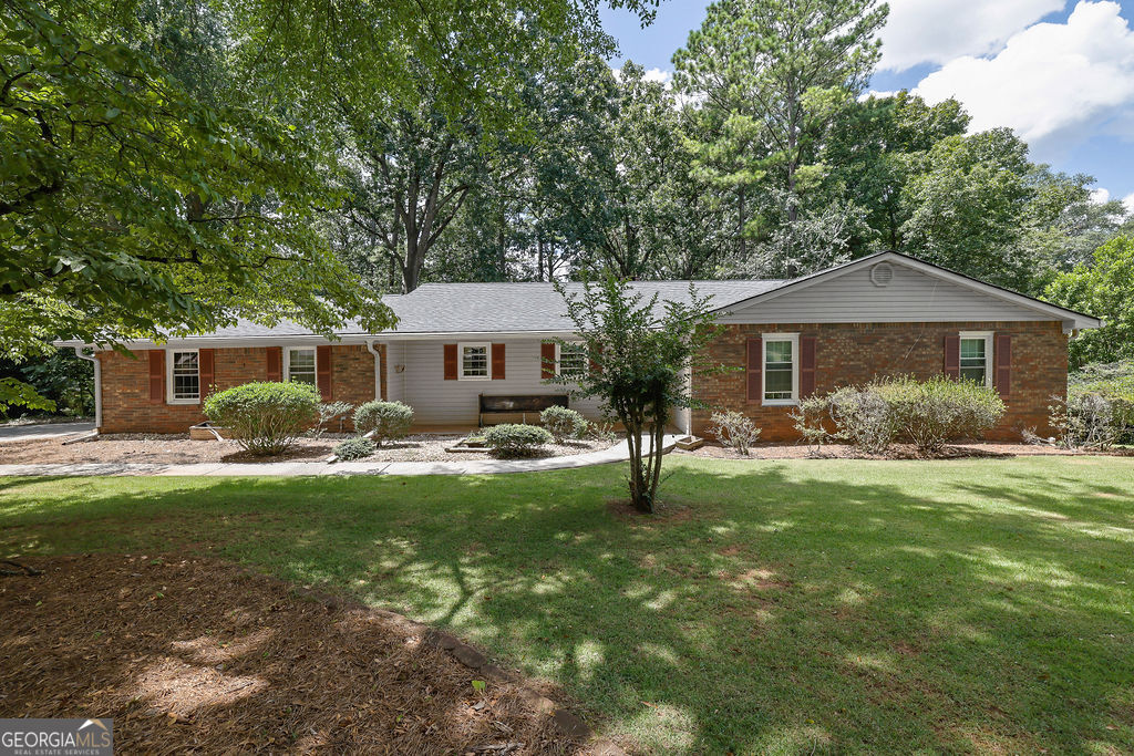Get ready to call this house your next home or investment property! This 4 sided brick ranch on a finished basement is located in a community without any community association or rental restrictions. The seller has taken great care of the home and has made several updates which include: New Roof (2025), New HVAC (2025), New Water Heater (2025), New Electric Box (2025), Fresh Paint, and much more. The main level features an open floorplan where the kitchen opens up to both the dining room and family room, 3 bedrooms, 2 full baths, and access to a screened in deck. Hardwood floors run throughout the common areas and the primary suite. The primary suite boasts an updated bathroom (2023). The lower level details a bedroom, full bath, laundry room, 2 unfinished rooms perfect for storage, and a large common room with a fireplace. The backyard is fenced and wooded - allowing for privacy. The Kennesaw Mountain Battlefield entrance is right outside the neighborhood and ready to be enjoyed by any fitness enthusiast or history buff. This house is a short drive to Kroger, Downtown Marietta, and endless shopping, dining, and recreation options. Located in the amazing Marietta High School district with Burress Elementary and Marietta Middle as the feeder schools. This house will not last long, get your offers in today!