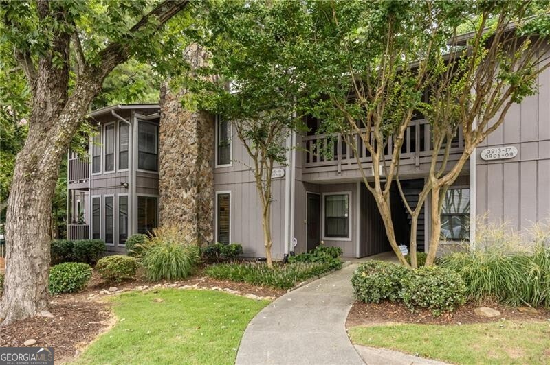 Beautifully Renovated, Move-In Ready Condo in Prime Tucker Location! This pristine second-floor unit offers serene views of the wooded rear grounds and is loaded with upgrades. A tiled entryway welcomes you into a spacious fireside family room featuring a gas-log fireplace, perfect for cozy evenings. The dining area flows seamlessly into the updated kitchen, which boasts tile flooring, granite countertops, a newer stove and dishwasher, and an oversized laundry room just off the kitchen for added convenience. The split-bedroom floor plan ensures privacy, with each generously sized bedroom offering its own ensuite bath with granite countertops and large closets. Fresh interior paint, new carpet, wood blinds throughout, updated light fixtures and ceiling fans, and a new water heater add to the home's turnkey appeal. A SimpliSafe alarm system is also included for peace of mind. Enjoy a gated community with fantastic amenities including a swimming pool, pickleball courts, picnic and fire pit area and well-maintained common areas. The $321/month HOA covers grounds, water, trash, exterior maintenance (including painting and roof), pool, and pickleball facilities. Ideally located near I-285, Emory University, the CDC, and vibrant Downtown Tucker-this home combines comfort, convenience, and value!