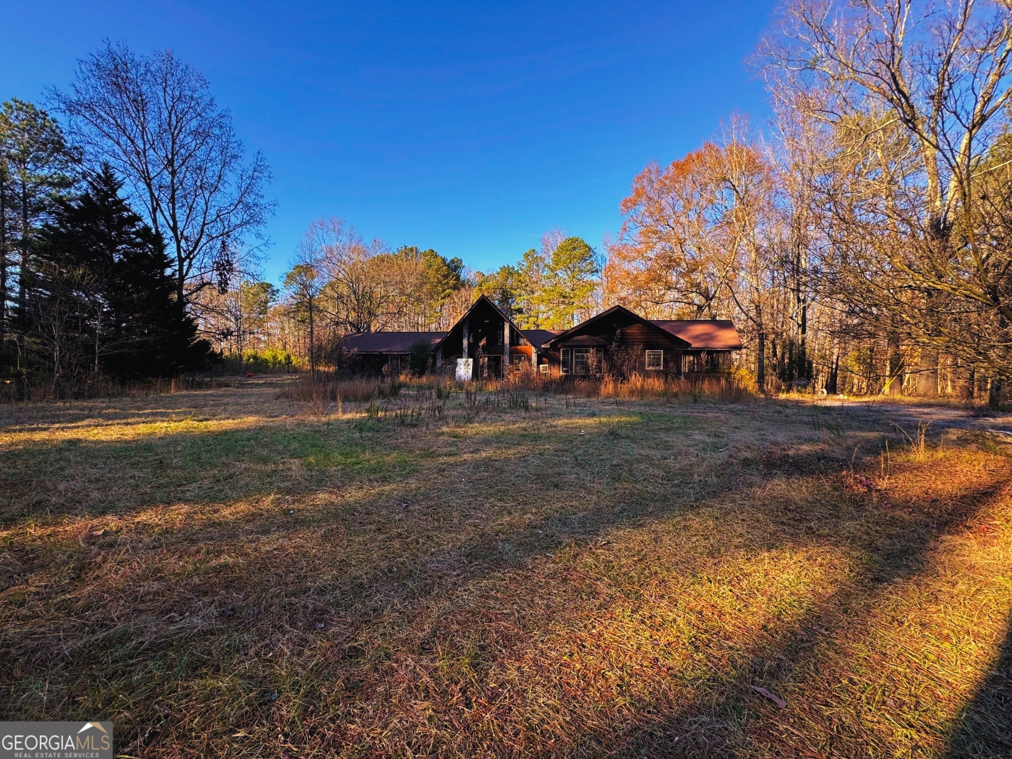 This 5000+ square foot fixer-upper home in Spalding County, nestled on over 39 acres of picturesque land, has MASSIVE upside. This expansive lot offers the perfect blend of peace, privacy, and possibility. Imagine the potential of transforming this space into a personal oasis or realizing a lucrative development opportunity. The existing structure, though in need of some TLC, holds the promise of becoming a stunning masterpiece with the right vision and creativity. Whether you're an aspiring homeowner with a passion for renovation or a savvy investor seeking the next big project, this property is brimming with potential. Embrace the tranquility of country living while still being a short drive away from local amenities and attractions such as Tanger Outlets and Noah's Ark Animal Sanctuary. This is more than just a piece of land, it's a chance to create something truly special. Act now before it's too late!