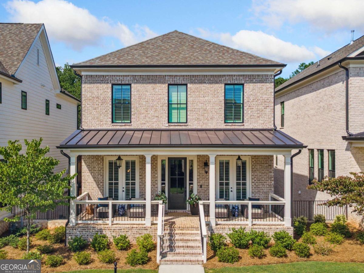 Stunning 4 sides brick home in the Waterside gated luxury community along the Chattahoochee river! Welcome to refined living in this beautifully upgraded 4-sides brick home.Every detail of this residence has been thoughtfully curated, starting with custom-built cabinetry featuring upper shelving above the refrigerator, soft closing drawers, roller-shelf in the pantry, and custom shelving by Closets by Design in every closet throughout the home. Enjoy elegant plantation shutters on every window, new designer light fixtures, and custom indoor paint that brings warmth and cohesion to every space. Two of the bathrooms are elevated with shower niches, and the secondary bath features a frameless glass shower door upgrade. Durable and stylish, hardwood flooring extends across all levels of the home. Unique to this home, each floor includes a spacious linen closet pre-framed to accommodate a future elevator, offering long-term convenience and flexibility. The garage is EV-ready with plenty of storage & hosts the Rheem tankless water heater. Outdoors, the professionally reseeded front and backyard grass provide lush green space, with landscaping fully maintained by the HOA. Private wooded backyard views are seen year around! Step outside your door to enjoy luxury community amenities including a clubhouse with fitness center, sparkling pool and cabana, four pickleball courts, a fire pit, and a pavilion with grilling station and bar, all set alongside the scenic Chattahoochee River. Just minutes away, discover Peachtree Corners Town Center, offering upscale dining, shopping, and entertainment. Don't miss this rare opportunity to own a meticulously maintained home in one of the area's most desirable gated communities at Waterside!