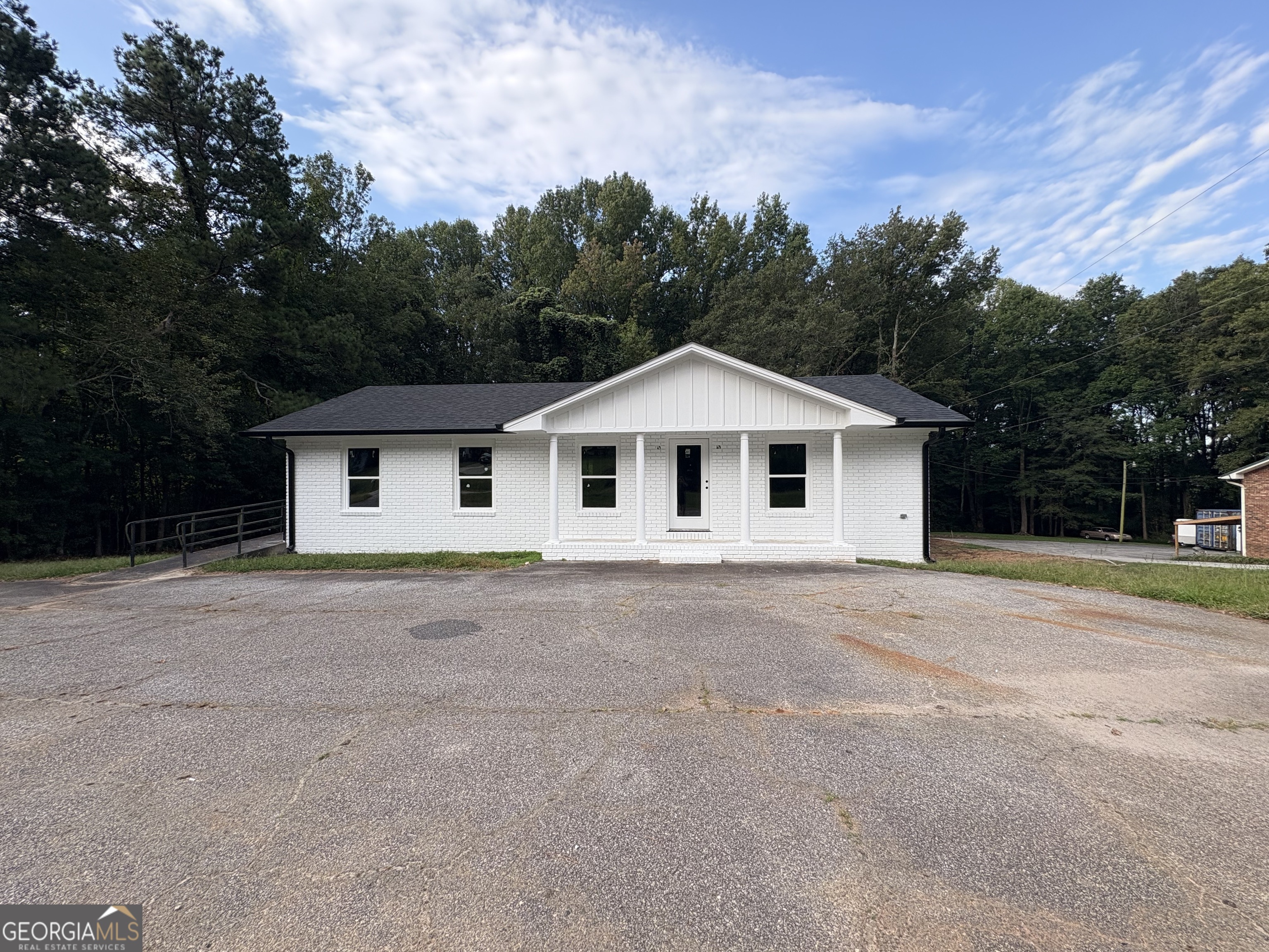 Limitless Possibilities in Carnesville! This 2,400 sq. ft. commercial building offers the perfect canvas for your business dreams. Located in the heart of Carnesville, it features prime road frontage and ample parking, ensuring maximum visibility and accessibility for customers and clients alike. Recently updated with a new architectural roof, windows, exterior doors, fascia, gutters, and a board-and-batten gable, the building shines with a fresh white exterior that sets the tone for professionalism and charm. Inside, the building is a blank slate-ready for your unique vision. With 1,200 sq. ft. on the main level and 1,200 sq. ft. downstairs, you'll have endless flexibility to design a layout that fits your needs, whether retail, office, showroom, or creative space. Don't miss this chance to make your business a reality in a location that offers both character and opportunity.