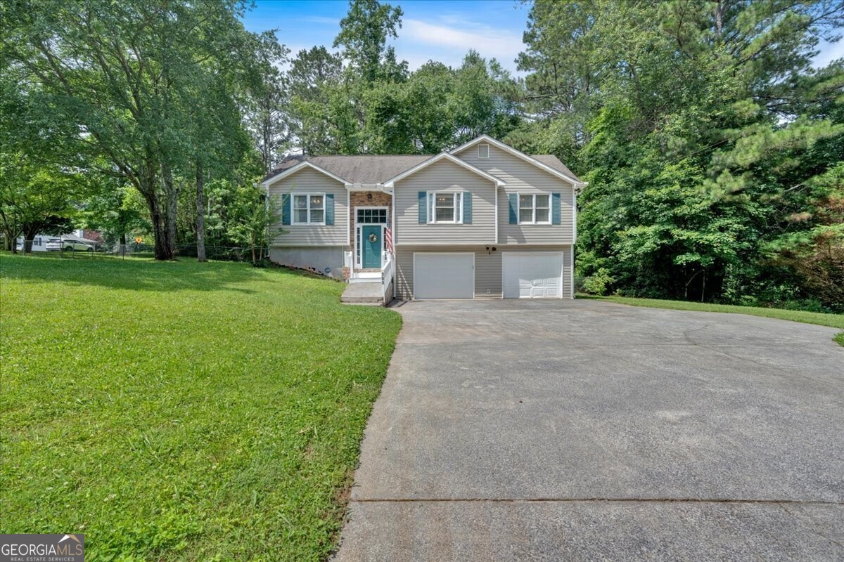 Welcome to this inviting 3-bedroom, 2-bath home tucked away on a generous lot with NO HOA to hold you back. From the moment you step inside, you'll love the warm feel of the updated kitchen featuring sleek stainless steel appliances and stylish LVT flooring that flows throughout the main living areas and bedrooms. The spacious primary suite offers your own private retreat with a walk-in closet and an en-suite bathroom complete with double vanities. Need extra space? The large bonus room downstairs is perfect for a man cave, home gym, kids' playroom, or just extra storage! Step outside and picture your summer gatherings in the huge fenced backyard perfect for gardening, BBQs, or even that dream pool you've always wanted. And with no HOA, you've got the freedom to park your RV or boat, build a workshop, or make this space truly your own. Ideally located with quick access to I-75 and an easy drive to both Cartersville and Canton this one checks all the boxes. Don't miss out on this gem!
