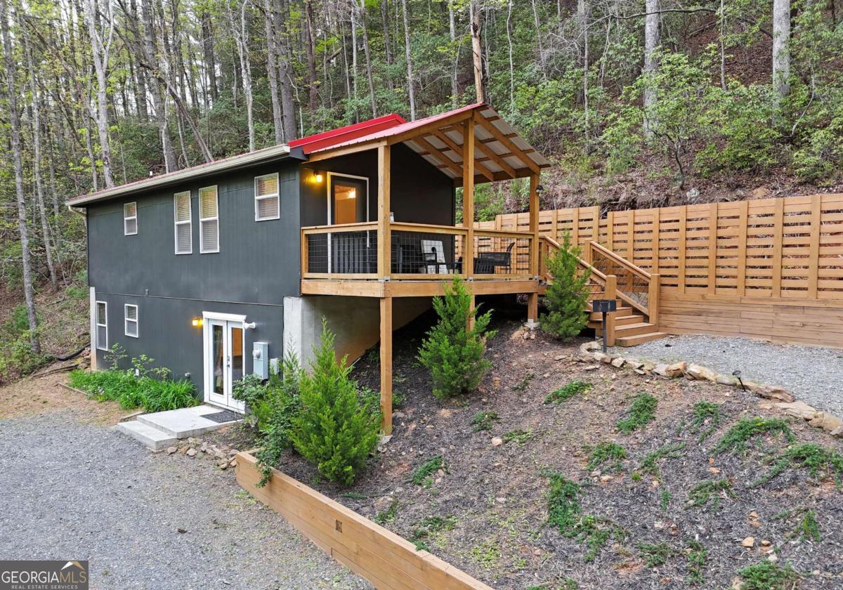 Perfect Mountain Retreat in Cherry Log - Between Ellijay & Blue Ridge! Welcome to your dream escape in the heart of the desirable Little Rock Creek area! Nestled perfectly between Ellijay and Blue Ridge, this cozy 2-bedroom, 2-bath cabin offers the ultimate mountain getaway experience, with all the charm and comfort you could want. Step inside to discover a fantastic layout with thoughtfully curated decor, creating a warm and inviting atmosphere. The cabin comes fully furnished and turnkey, already a successful Airbnb with impressive rental income-$48,776 in 2024 and $45,828 in 2023. Outdoors, enjoy your morning coffee or evening wine on the private back deck overlooking nature, complete with a hot tub, firepit, and peaceful sounds of Little Rock Creek, which flows just across the street. The decks are perfect for relaxing, grilling, or spotting local wildlife and listening to the birds sing. Whether you're looking for a serene personal retreat or a proven investment property, this cabin truly has it all-location, comfort, and income potential. Don't miss your chance to own a piece of mountain paradise in one of North Georgia's most sought-after areas!