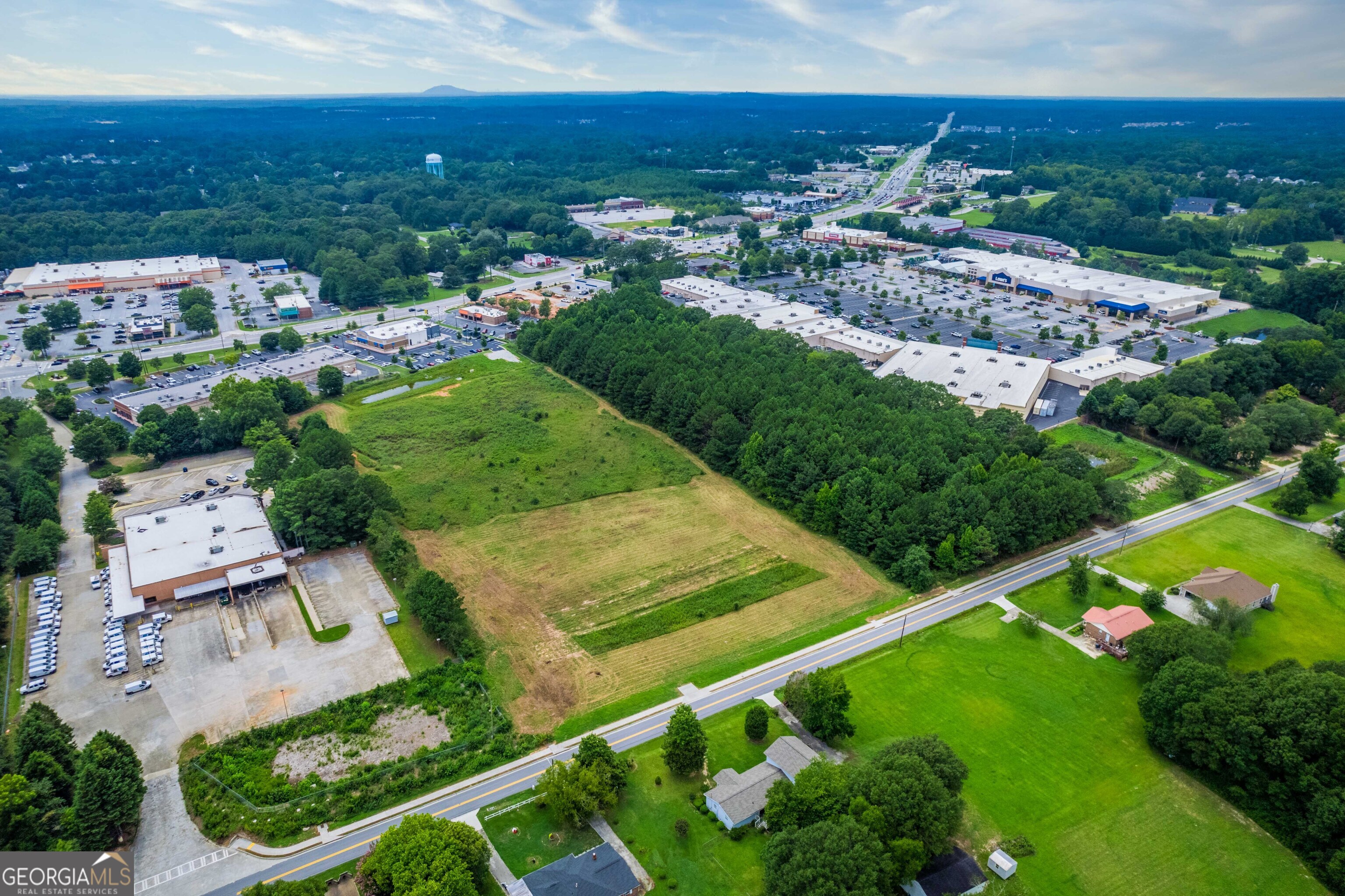 a developer/commercial use dream! With 288 ft of road frontage for pecan street and a unique access from 78 hwy! a total of 6.45 acres, currently zoned Commercial Highway.