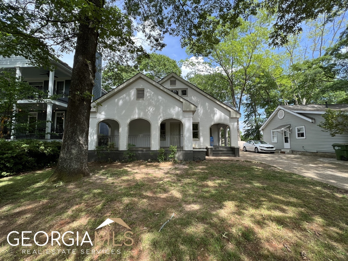 Beautifully renovated 1930's home that has been converted into a two level duplex. This 3 Bedroom, 3 Bath main level unit features an open concept floorplan with huge family room, custom cabinetry kitchen with quartz countertops & stainless steel appliances, dining area, spacious fireside primary bedroom with private porch & custom walk-in closet, primary bath with dual vanities & tiled shower, large guest bedrooms, laundry room, deck & off street parking. Stunning interior details with hardwoods & tile throughout. Just minutes from downtown Atlanta or Decatur and walking distance to the Beltline & Little Five Points.