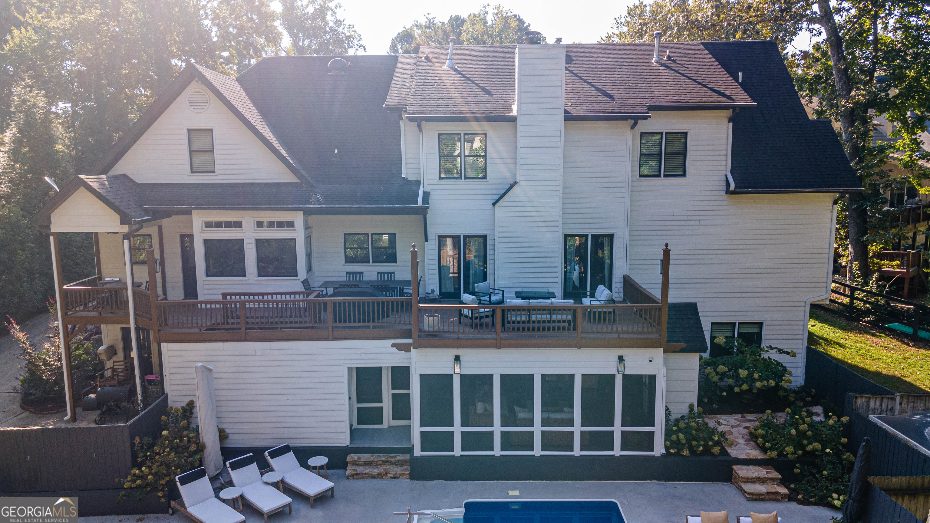 Welcome to this immaculate, updated 5-Bedroom, 4.5 bath modern farmhouse, comfortably situated on a tree-lined cul-de-sac, in one of the top-rated communities in the entire area - Medlock Bridge subdivision. This home exudes character and charm. The exterior of the home has been transformed from traditional to modern farmhouse with carefully placed details that give a nod to the original custom build. The well-manicured lawn serves as a subtle frame, while entering the driveway that provides access to the 2 car garage or basement level private entrance. The first level of this well-maintained home includes the primary bedroom with a newly renovated bath and closet system. This level also includes additional living spaces that include family room with wet bar, formal dining and serving room. The kitchen features a breakfast nook and new Kitchen Aid appliances. From the breakfast nook or family room, walk out to the oversized deck, that spans the length of the home. Enjoy a cup of coffee or take in the fresh air while overlooking the pool and backyard oasis filled with limelight hydrangeas. The second level of this charming home features three large storage spaces, an amazing loft for relaxation and entertainment, as well 3 bedrooms, each with access to a bathroom. Enjoy additional living space in the basement which includes a full kitchen, laundry room, game area, gym and bedroom. Step outside and enjoy the spacious, screened-in terrace, which is yet another wonderful space to entertain friends and family during warm Georgia summer days or brisk fall evenings. Enjoy the pool and spacious pool deck with friends and family for eight wonderful months of the year. This home is an entertainers dream. Consider being a part of this peaceful Atlanta suburb that boasts top-rated schools, safe communities, minutes away from top-notch grocery stores, as well as the future home to the 43-acre Medley, a new development that will feature retail, restaurant and entertainment spaces. We invite you to be part of this amazing Johns Creek home opportunity.