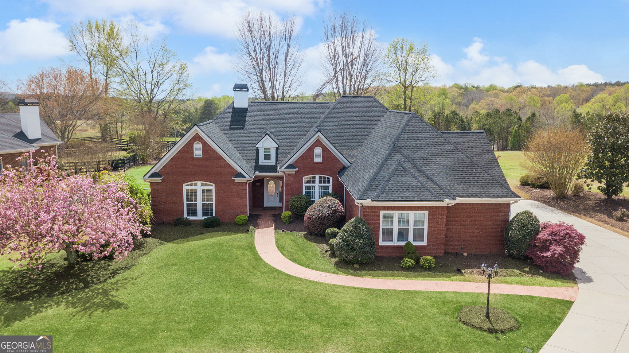This stunning single-story brick ranch home offers sweeping views of the golf course and promises to be your ideal retreat. Nestled on nearly three-quarters of an acre in the highly desirable Gold Creek Subdivision, the property provides both a peaceful setting and convenient access to downtown Dawsonville and Dahlonega. Inside, the home is filled with natural light and features soaring ceilings over 10 feet high. The thoughtfully designed layout includes a galley kitchen with a breakfast room that flows seamlessly into the family room, complete with a cozy gas fireplace. A formal dining room and separate laundry room add to the home's functionality. The expansive owner's suite is a true haven, showcasing a recently updated en-suite bathroom with a spacious glass shower, jetted tub, dual vanities, and walk-in closets. Two additional bedrooms, each with walk-in closets, share a Jack and Jill bathroom, while a dedicated office provides flexibility to serve as a fourth bedroom if desired. A versatile upstairs flex room, accessible through the oversized three-car garage, offers abundant storage and endless possibilities. One of the home's most captivating features is the exquisite sunroom, perfect for relaxing while enjoying the picturesque views. Outdoors, multiple patios and generous green space create ideal areas for entertaining or unwinding with family and friends. Recent updates, including fresh interior paint, a brand-new roof, and the addition of a Generac generator, make this home truly move-in ready. With its blend of comfort, elegance, and practicality, this property offers the rare chance to own a slice of paradise in one of the area's most sought-after communities.