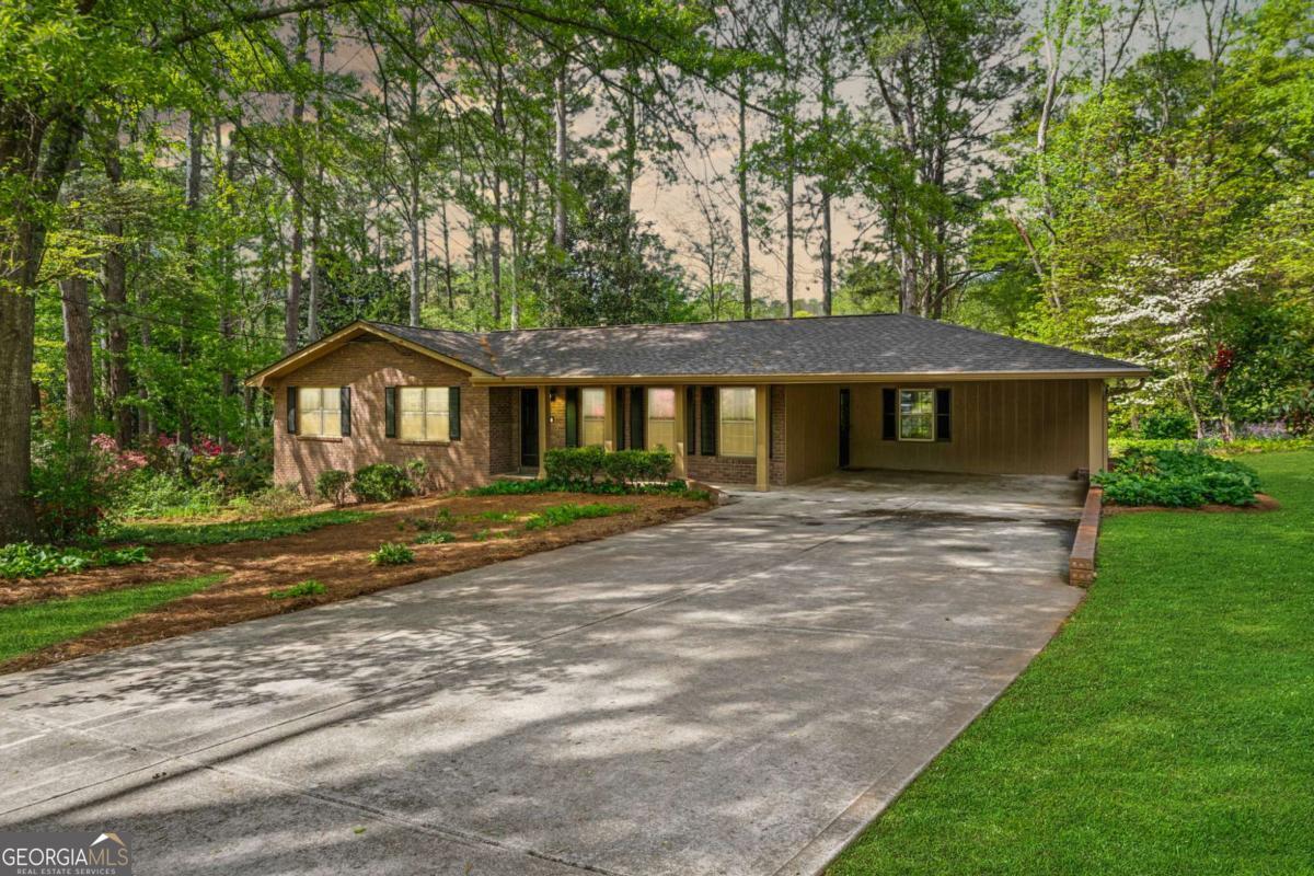 Your East Cobb Escape Awaits! Tucked away in a quiet East Cobb cul-de-sac, this stunning 4 bedroom true ranch offers a unique blend of modern amenities, classic style, and private outdoor space, all without the burden of an HOA. As you step inside, you'll be greeted by the warm, natural light that fills the open-concept living area. Rich oak hardwood floors flow seamlessly throughout the main level, connecting the spacious living and dining rooms to a beautifully updated kitchen. Completed in 2025, this kitchen renovation features quartz countertops, stainless steel appliances, a breakfast bar, and sleek white cabinetry. Perfect for cooking, entertaining, or enjoying a quiet morning. A cozy family room with a fireplace sits just off the kitchen, accompanied by a convenient laundry area. The primary bedroom boasts an updated en suite bath, while two large secondary bedrooms offer generous closets and plenty of natural light. An updated hallway bath completes the main level. Downstairs, the finished walk-out basement offers a world of possibilities, featuring a bright bonus room, a fourth bedroom that could serve as an office or gym, and a handy workshop. Outside, you'll find a peaceful, landscaped backyard retreat perfect for outdoor activities, gatherings, or relaxation. With its prime location near top schools, major highways, parks, and shopping, this home offers the perfect balance of tranquility and convenience. This is a rare opportunity to own a worry-free, move-in-ready home in a highly sought-after location. Don't miss your chance to make it yours.