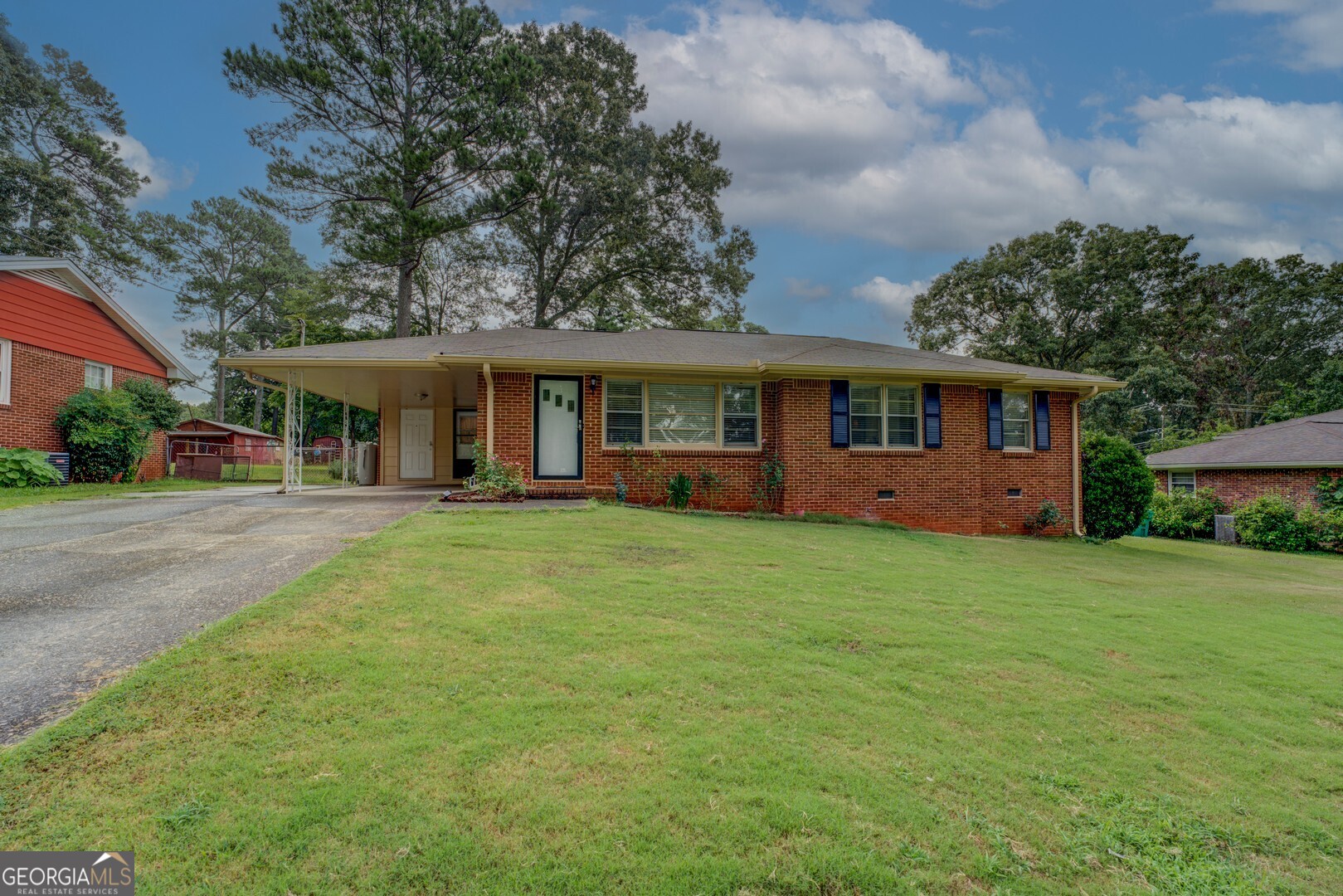 Extra well maintained 3 bedroom, 1.5 bath all brick ranch with carport and 2 quality outbuildings. Living room/ dining room combo, breakfast area in kitchen, separate den. Beautiful hardwood floors, screened porch out to fensed, private back yard great for pets/garden. New exterior trim paint. This one is move-in ready!