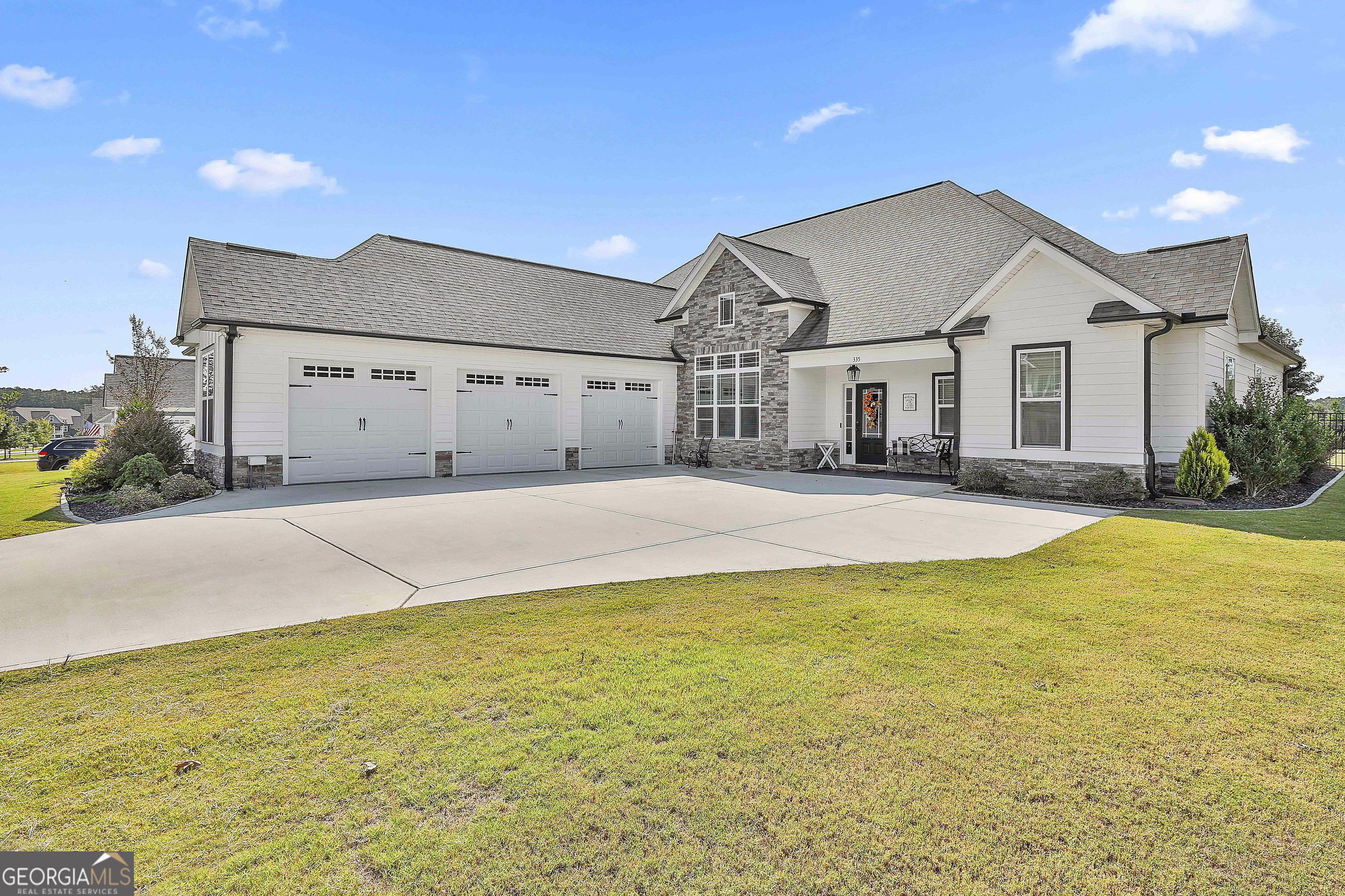Southern Living Showstopper in Sought-After Senoia! Tucked away in the desirable Fieldstone Subdivision, this beautifully crafted 4BR/3BA home with bonus room is a true gem-offering luxury, space, and timeless Southern style. Step inside the welcoming foyer for a glimpse of the backyard retreat, then move into the open-concept chef's kitchen featuring stainless steel appliances, gas cooktop, farmhouse sink, coffee station, soft-close cabinetry, double pantries, and a spacious island perfect for entertaining. The kitchen flows seamlessly into the cozy breakfast room, elegant dining room, and inviting great room with a stacked-stone fireplace. The owner's suite on the main level boasts a spa-inspired ensuite with frameless tiled shower, soaking tub, dual vanities, and custom closet system. Two additional bedrooms and a full bath complete the main floor. Upstairs, you'll find a private bedroom with full bath plus a large bonus room-ideal for a teen suite, guest space, home office, or fitness room. Enjoy year-round outdoor living with a covered patio featuring privacy shutters and Sunbrella shades-the perfect spot for morning coffee. Step outside to your resort-style saltwater pool with baja ledge, umbrella stations, auto-retractable awning, lighting, and pool cleaning system, all set within a professionally landscaped, private backyard oasis that includes a backyard fence, irrigation system, and a spacious lawn. The 3-car courtyard-entry garage offers soaring ceilings, commercial epoxy floors, full insulation, and a utility sink providing durable, clean, climate-controlled space perfect for a workshop, man cave, or extra storage. Neighborhood amenities include a pool, pavilion, and playground, plus golf cart access to parks and downtown Historic Senoia, known for its charm, shopping, and top-rated restaurants. This home truly has it all-luxury living, thoughtful design, and an unbeatable location!