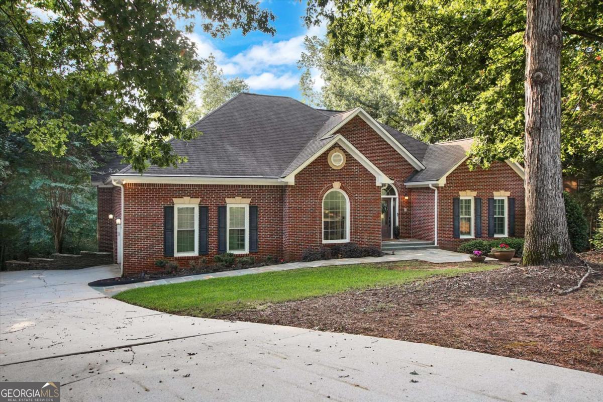 Imagine pulling into your private driveway at 8080 Lakemont Close, where gentle lake breezes welcome you to over 4,000 sq ft of living, well designed for any generation. Five bedrooms and 31/2 baths mean space for grandparents in the finished basement with its second kitchen, teens in the home theater, and everyone gathering by the outdoor fire pit. This home offers tons of storage, including a cedar closet for your most treasured possessions. Host effortless summer barbecues in the patio's built-in kitchen, then unwind in the hot tub as the sun sets over the water. Neighbors gather for tennis or a dip in the community pool-you'll love the established neighborhood feel, top-rated schools, and easy access to shopping, dining, and major interstates. Holidays and everyday moments take on new meaning here. Multiple outdoor living areas and bright, open interiors set the scene for celebrations big and small. Whether you're raising little ones, welcoming grandparents, or simply enjoying life's seasons, this home is where memories grow. Welcome to your forever home.