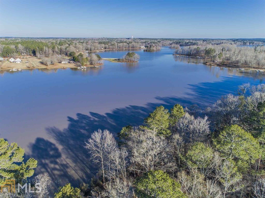 Located in the heart of Georgia's Lake Country, this opportunity has endless possibilities. This 1153+/- acre tract with 4000' on Lake Oconee, includes 881 acres in Morgan County (zoned: Lake-shore Town Center Overlay) and 272 acres in Putnam County (zoned: RM-3, Multifamily Residential). Purchase for development and benefit from over 2 miles of paved road with curb/gutter, frontage on 3 roads, and the water and sewer system partially in place. The lakefront access, dock, lakeside cabin, diverse wildlife and multiple ponds and food plots sites make it an outdoor enthusiasts dream. Merchantable pine and mature hardwoods throughout.