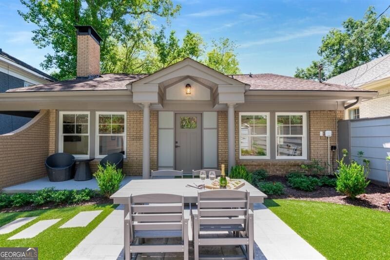 Fabulous FULLY FURNISHED renovated 3-Bedroom, 3-Bath Home, delightfully located 2 blocks from Piedmont Park, ready to be enjoyed for SHORT or LONG TERM. Enter through the professionally landscaped private courtyard garden terrace, designed for relaxation and entertainment, into a beautifully decorated open floor plan with vaulted ceiling radiating natural light. Lovely Chef's Kitchen featuring Pekten countertops & backsplash, high-end sleek white cabinetry, Cove Stainless Subzero & Dishwasher, Dining Island, built-in Microwave, 4-burner Gas Stove with griddle, and thoughtfully stocked with Kureig & Ninja coffee makers, Nutribullet, Crockpot, etc. open to Family Room w/ gas fireplace surrounded by Pekten wall finishes. Main Level also includes 2-Bedrooms (King & Queen Beds) flanked on either end of Kitchen w/ en-suite (tub/shower combo, & shower only) Bath's. New Electrolux stacked Washer & Dryer and large storage closet in hallway. Take the modern circular staircase to the Upper Level Bedroom suite with office area, walk-in closet, and Bath with a fabulous triple rain head shower. Modern lighting, along with recessed lighting, and automatic lighting sensors in each closet, as well as under each vanity. White oak flooring throughout w/ tile flooring in each Bath. Exceptional features include 55" Smart TV's in each room, window treatments with day & night settings, high speed internet. Hard to find off-street parking, permitted street parking, and excellent walkability to Piedmont Park, Trader Joe's, our fabulous Beltline, Ponce City Market, shopping, restaurants, and many other attractions Atlanta has to offer, just a short Uber ride away. Perfect home and location for Film & Television Production Housing, alternative Housing for a renovation project, or to accommodate an insurance relocation. A gem!!