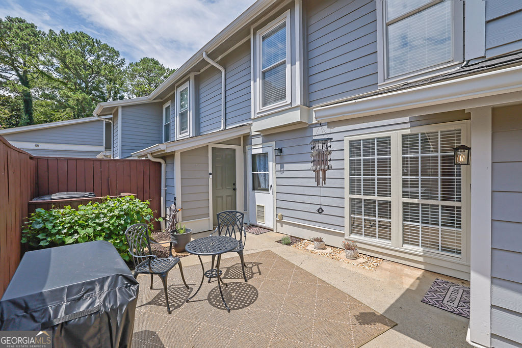 Welcome home to this charming East Cobb condo located in the highly sought-after Walton School District! This beautifully updated home offers the perfect blend of comfort and convenience. Step into a private, gated courtyard with exterior storage before entering the inviting living space. The updated kitchen features granite countertops, stainless steel appliances, and a modern finish, perfect for entertaining or everyday living. The roommate-style floor plan provides privacy with two spacious bedrooms, each with its own en-suite bathroom. Laundry is conveniently located on the main level. Enjoy access to a community pool, plus easy proximity to shopping, dining, grocery stores, and more. Just under 15 minutes to downtown Roswell and the Chattahoochee Nature Center! No rental waitlist at this time, making it an excellent opportunity for investors or homeowners alike. HOA covers water and sewer, insurance on the building, pest and termite control, pool, trash pick-up, and exterior maintenance including roof. Don't miss this move-in ready gem in one of East Cobb's most desirable communities!