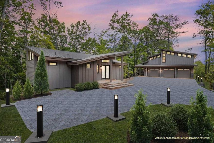Step into a world of refined mountain living at this exquisite contemporary estate in the Summit, a gated enclave just across from shimmering Lake Burton, less than 5 minutes to lake access at LaPrades Marina. Perched on over an acre of rolling, wooded landscape, this 3BD / 3BA modern masterpiece with a 1 BD / 1 BA guesthouse blends sophisticated design with the soothing sights and sounds of nature---offering seasonal lake views, high-end finishes, and the warmth of home around every corner. From the moment you arrive, a striking, well-lit entryway welcomes you, framed by mature trees, fragrant mountain air, and ample guest parking. Inside, the home is a feast for the senses: rich wood textures, soaring vaulted ceilings, and expansive JELD-WEN casement windows that bathe each space in golden natural light. Soft shiplap walls and handpicked designer fixtures create a cozy yet elevated aesthetic, while the stacked stone fireplace crackles with warmth---perfect for cool evenings. The chef's kitchen is a dream of taste and touch: sleek quartz countertops, a deep farmhouse sink, French door refrigerator, gas range, and a hidden walk-in pantry with a full coffee and beverage bar---ideal for quiet mornings and lively entertaining alike. Gather in the glamorous dining room, where massive picture windows frame verdant backyard views and a chic bar area invites evening cocktails. Wander outside to find a stunning custom stone gas firepit, inviting hot tub, and the soothing symphony of rustling leaves, birdsong, and mountain breezes. Retreat to the primary suite, a calming sanctuary with vaulted ceilings, peaceful views, and a reclaimed barn door opening to an ensuite spa bath. Here, indulge in a luxurious oval soaking tub, quartz vanity, infinity-glass shower, and custom walk-in closet---a sensory escape designed for relaxation. On the terrace level, enjoy a second media/living room with a full kitchenette, a spacious second suite, and a third bedroom and bath. Glass doors lead to a stone terrace, surrounded by lush greenery and the scent of pine and wildflowers. The detached 3-car garage is more than a place to park-fully climate-controlled, it doubles as a workshop, recreation space, or dream studio. Above it, the 1BD / 1BA guesthouse is a private, beautifully appointed haven with a full kitchen, airy living and dining areas, a charming reading nook, and its own balcony overlooking the lake---a perfect retreat for guests or lucrative rental potential. With over 1,000 square feet of decks, patios, and porches, this home invites you to feel the seasons, breathe the mountain air, and truly live the lake life---without the waterfront maintenance. And with two whole-house generators, peace of mind comes standard. Located just one mile from LaPrade's Marina, where lake life comes alive with three restaurants, boat rentals, and more; less than 10 minutes from the exclusive Waterfall Club; and, less than 20 miles from thriving downtown Clayton for award-winning dining, boutique shopping, and local culture galore. This property truly offers the best of both worlds: private, luxurious mountain living with lake access and vacation-like amenities at your fingertips. FEE SIMPLE ownership means flexibility, freedom, and rental potential---an increasingly rare opportunity in this coveted corner of northeast Georgia. Do NOT miss your chance to own a fully immersive, turnkey mountain-lake experience. This could be your long-awaited slice of heaven on Lake Burton.