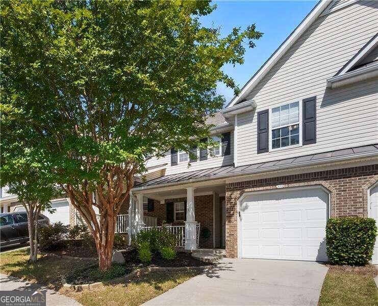 THIS is one of the best and most affordable communities in Woodstock/Holly Springs! Fox Creek is a well-maintained, fee simple townhome community located conveniently off Main Street/Hwy 5, near neighborhood shopping and easy access to highways and schools.   ** 415 Red Coat Lane features the sought-after 2 BR, 2.5 BA floorplan, including a spacious private loft space. **   The spacious front porch is a great place to enjoy cool mornings and evenings. The entry foyer features a storm door, allowing light to pass through the space to the open concept main living area. There are 2 closets downstairs. Entering the Living room, Kitchen, and Dining area, you feel right at home with nice large windows and a cozy fireplace. The Kitchen and Dining area overlooks the rear patio and access to the backyard. Upstairs you'll find a perfect spot for a home office, gaming space, or hobby area in the loft! The Primary Bedroom is oversized and features a walk-in closet. The Secondary Bedroom is a queen-sized room with direct access to the private bath. The one-car garage has space for a vehicle AND storage. The HVAC system was replaced in 2018. Termite bond and roof are part of the HOA maintenance responsibility.