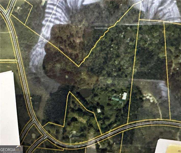 11.5 acres of prime residential property. Ideal for family compound. Home could be renovated or removed. Beautifully wooded rolling fields located in one of the fastest growing counties per capita in the US. Conveniently located in sought-after North Paulding High School district, near restaurants, shopping, dining, colleges, national parks, businesses, and medical facilities. Only 30 minutes to Atlanta International airport and 15 minutes to Paulding County Airport! Easy access to expressways including I-75 and I-20. Land features mature hardwoods including oaks, hickory, and more. Most pine trees were removed approximately 50 years ago and replaced with (now mature) hardwoods. Prime development opportunity!