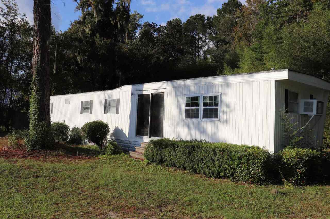 Many possibilities, subdivision, potential commercial. Older mobile home on property, private well and septic tank. (0.23 acre ground lease for cell tower, not included in sale)