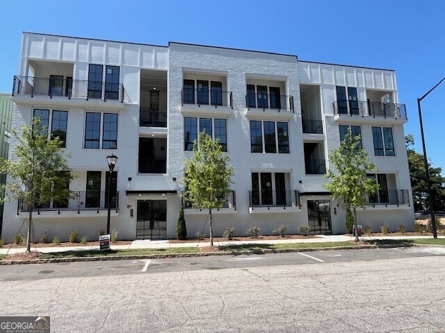 Limited time offer***3.99% interest rate*** Set in the lively heart of West Midtown, Longreen boasts a tranquil environment for residents to enjoy. Longreen Park encourages community gathering, uniting friends, families, and neighbors alike. The future BeltLine expansion to the area will further enhance Longreen's connectivity to West Midtown. This 2 story 3-bedroom, 2 and a half bath home is the ultimate in spacious urban living. The primary level of the Executive floor plan showcases a seamlessly integrated kitchen that flows into the family room, accompanied by a versatile flex space suitable for either a home office or a refined dining setting. Transitioning from the family room, you'll discover a terrace that extends the living area outdoors, creating an ideal setting for both dining al fresco and hosting social gatherings. Ascending to the second floor, you'll find the primary suite with an en-suite bath, thoughtfully designed with the inclusion of dual walk-in closets, offering an abundance of storage solutions. Complementing this, two secondary bedrooms accompanied by a shared bathroom for optimal convenience and comfort. The convenience of a two-car tandem private garage is located on the bottom level. **DISCLAIMER: Kindly note, the provided photos offer a glimpse into the forthcoming home currently under construction. Variations in colors and materials may be present.