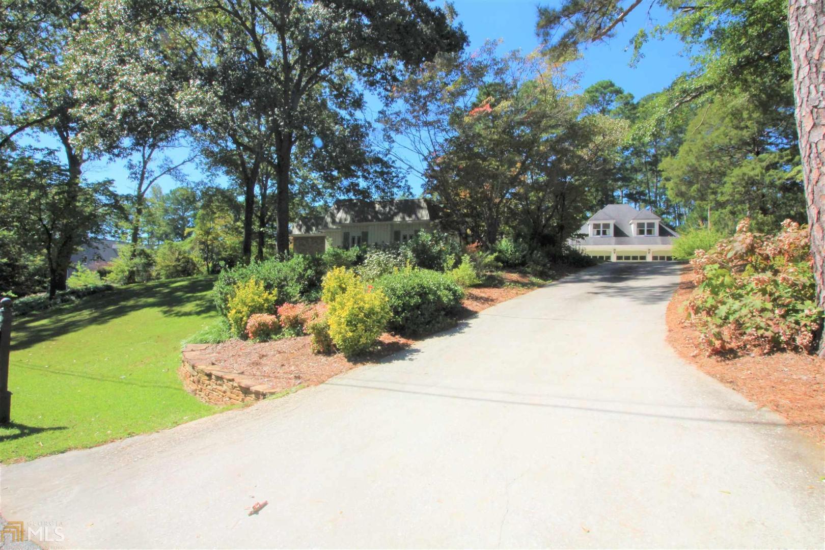 A RARE BEAUTY NESTING IN NEWNAN’S SOUGHT AFTER IN TOWN NEIGHBORHOOD! GLEAMING HEART PINE FLOORS THROUGHOUT, NEWLY REMODELED MASTER SUITE WITH MARBLE COUNTERTOPS, SUBWAY TILE SHOWER, SECONDARY LAUNDRY ROOM WITH ADDITIONAL PLUMBING FOR A SECOND SINK, CUSTOM CLOSET SYTEMS IN ALL BEDROOM CLOSETS. OVERSIZED GREAT ROOM WITH FIREPLACE, HERRINGBONE PATTERNED FLOORING, FRENCH DOORS LEADING ONTO STONE PATIO, LOTS OF GORGEOUS WINDOWS AND MOULDING. DINING ROOM BOAST OF CUSTOM BUILT INS WITH LIGHTING MORE OF THAT HEART PINE FLOORING LAID IN A BEAUTIFUL PATTERN. KITCHEN OFFERS GRANITE TOPS, TILE BACKSPLASH & STAINLESS APPLIANCES WITH A GAS COOK TOP. FAMILY ROOM SHOWING AS A BREAKFAST ROOM – BUYERS CHOICE COMPLETE WITH STACKED STONE FIREPLACE, BATTEN & BOARD WALLS WITH BUILT INS OVERLOOKING YOUR PRIVATE AND WONDERFUL FENCED IN BACK YARD WITH LARGE PATIO - BREAKFAST ROOM WITH OVERSIZED WINDOW, KEEPING ROOM WHICH SERVES AS THE OFFICE OR TV ROOM. FULL MUDROOM COMPLETE WITH LAUNDRY, STORAGE & POWDER ROOM. DETACHED 3 CAR GARAGE WITH FULL APARTMENT - GREAT FOR INCOME PRODUCING OR MOTHER IN LAW APARTMENT, DON’T MISS ALL OF THE EXTRA STORAGE IN THE BACK OF THE GARAGE. WONDERFUL IN TOWN PROPERTY WITH LARGE LOT & ADDITIONAL FENCED IN AREA FOR YOUR 4 LEGGED CHILDREN. WALK TO DOWNTOWN NEWNAN SQUARE AND ENJOY WONDERFUL IN TOWN SCHOOLS! JUST 5 MINUTES TO TOWN, I-85, HOSPITALS & ASHLEY PARK.