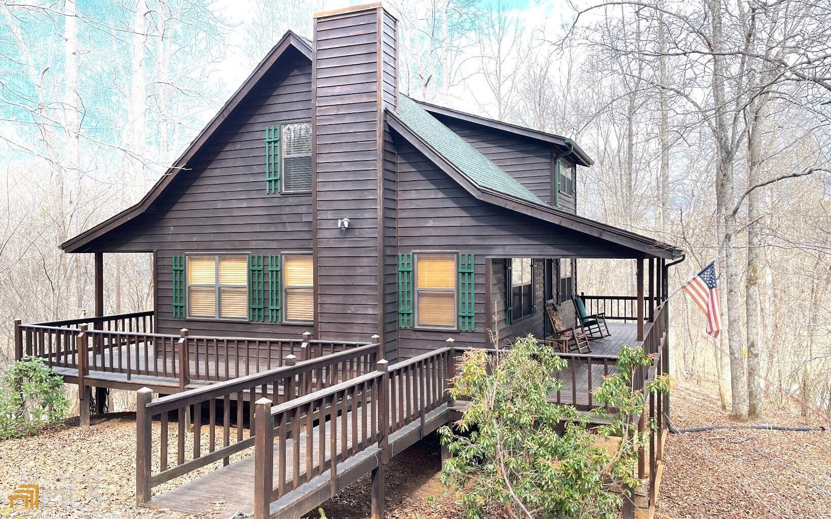 QUALITY BUILT PRIVATE CABIN IN THE NORTH GEORGIA MOUNTAINS! This 3 bedroom/2.5 bathroom cabin offers a spacious wrap-around covered deck, an open floor plan, great room with cathedral ceiling and wood-burning stone fireplace, dining area, kitchen, 1 bedroom on each level, a living room, laundry room/workshop, and the peace & quiet of the mountain life.