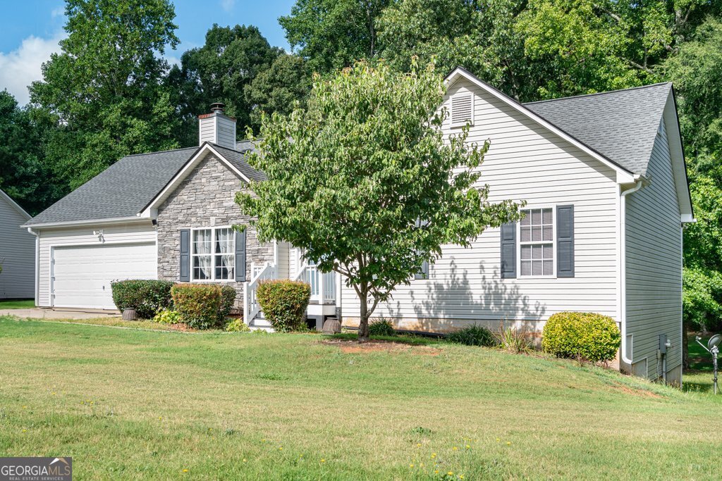 Charming Ranch with Full Unfinished Basement on a Large Lot - No HOA! Welcome to this beautifully maintained 3-bedroom, 2-bath ranch nestled on a spacious lot in a quiet and quaint street of homes in Douglasville, GA. This move-in-ready gem features vinyl and stone siding for low-maintenance curb appeal and a timeless exterior style. Step inside to discover an inviting family room with a vaulted ceiling and a cozy stone-accented fireplace, perfect for relaxing evenings. The neutral paint palette throughout offers a fresh, airy feel and serves as a perfect backdrop for any style decor. The kitchen and dining area seamlessly flow into the living space, creating a functional layout that is ideal for both everyday living and entertaining. The master bedroom is nicely sized and the bathroom has a separate shower and soaking tub. Downstairs, the full unfinished basement provides endless possibilities-already stubbed for a bathroom, it's ready to be transformed into additional living space, a workshop, or a home gym. Enjoy privacy and room to roam on your large lot with no HOA restrictions-bring your RV, boat, or build the backyard oasis you've always dreamed of! Don't miss your chance to own this fantastic home that blends comfort, potential, and peaceful living-schedule your showing today!