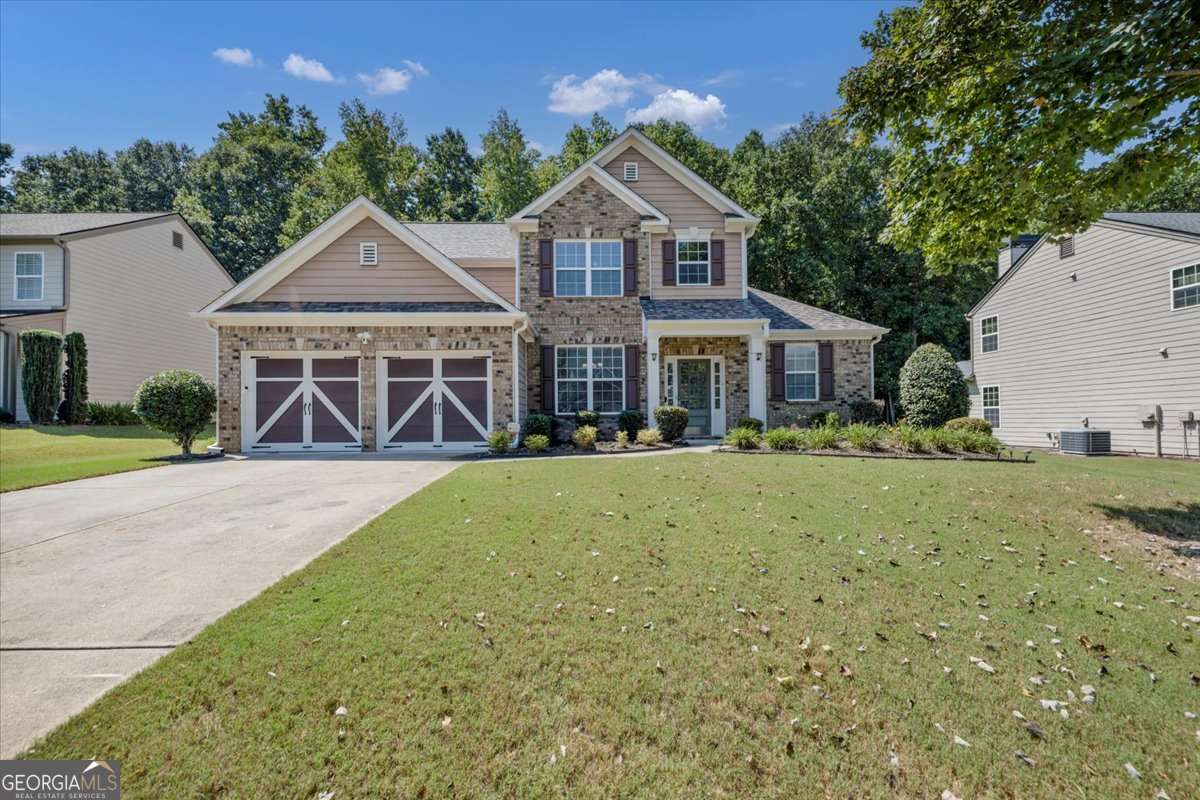 Beautifully maintained Craftsman-style home located in the highly sought-after West Forsyth area! This spacious home features a main-level primary suite with a large walk-in closet and a luxurious ensuite bath complete with double vanity, soaking tub, and separate shower. The open-concept main living area is filled with natural light and includes a cozy fireplace, a bright sunroom, and a modern kitchen with granite countertops and stainless steel appliances. Upstairs, you'll find three generously sized bedrooms and two full bathrooms, offering plenty of space for family or guests. Enjoy relaxing or entertaining outdoors on the covered patio. Perfectly located near top-rated schools, shopping, dining, and grocery stores - this home offers comfort, style, and convenience in one perfect package!