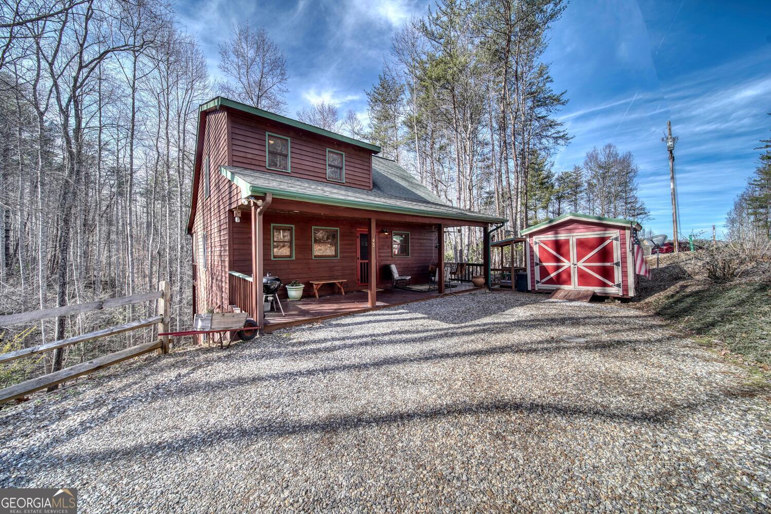 Seller to pay $500.00 toward inspections. North Georgia Mountain Cabin Located 10 minutes to Downtown Blairsville and only 20 minutes to the Popular Town of Blue Ridge. This Cabin Offers 3 Bedrooms, 2.5 Baths, a Loft and a Full Basement with very High Ceilings. This Can Be Your Private Cabin Retreat, Full Time Living or Vacation Rental for Extra Income. NO Restrictions on this Beautiful Wooded Piece of Land. There is a Master Suite on the Main Floor and One Upstairs. The Adorable Kitchen Offers a Farmhouse Sink, Newer SS Appliances and a Separate Coffee Bar. The Open Loft Can Serve as an Office, Living Room, Craft Room or an Extra Sleeping Area. In the Living Room the Eye Catching Wood Burning Fireplace with Rock Face Will Definitely get your Attention. Laundry is on the Main Floor, Large Closets, a Nice Screened in Back Porch and 2 Open but Covered Porches for Grilling and Enjoying the Private Wooded Yard. Generator, Gutter Guards, Truss Flooring System and a 10 X 12 Shed that's Perfect for Your Motorcycle or Other Equipment. The Workshop Area in the Basement can Easily be Finished off as an Entertaining Room for Movie Night or Table Games Like Pool, Air Hockey or Ping Pong. 720 S/f in basement. Call Today to Make Your Mountain Dreams a Reality!