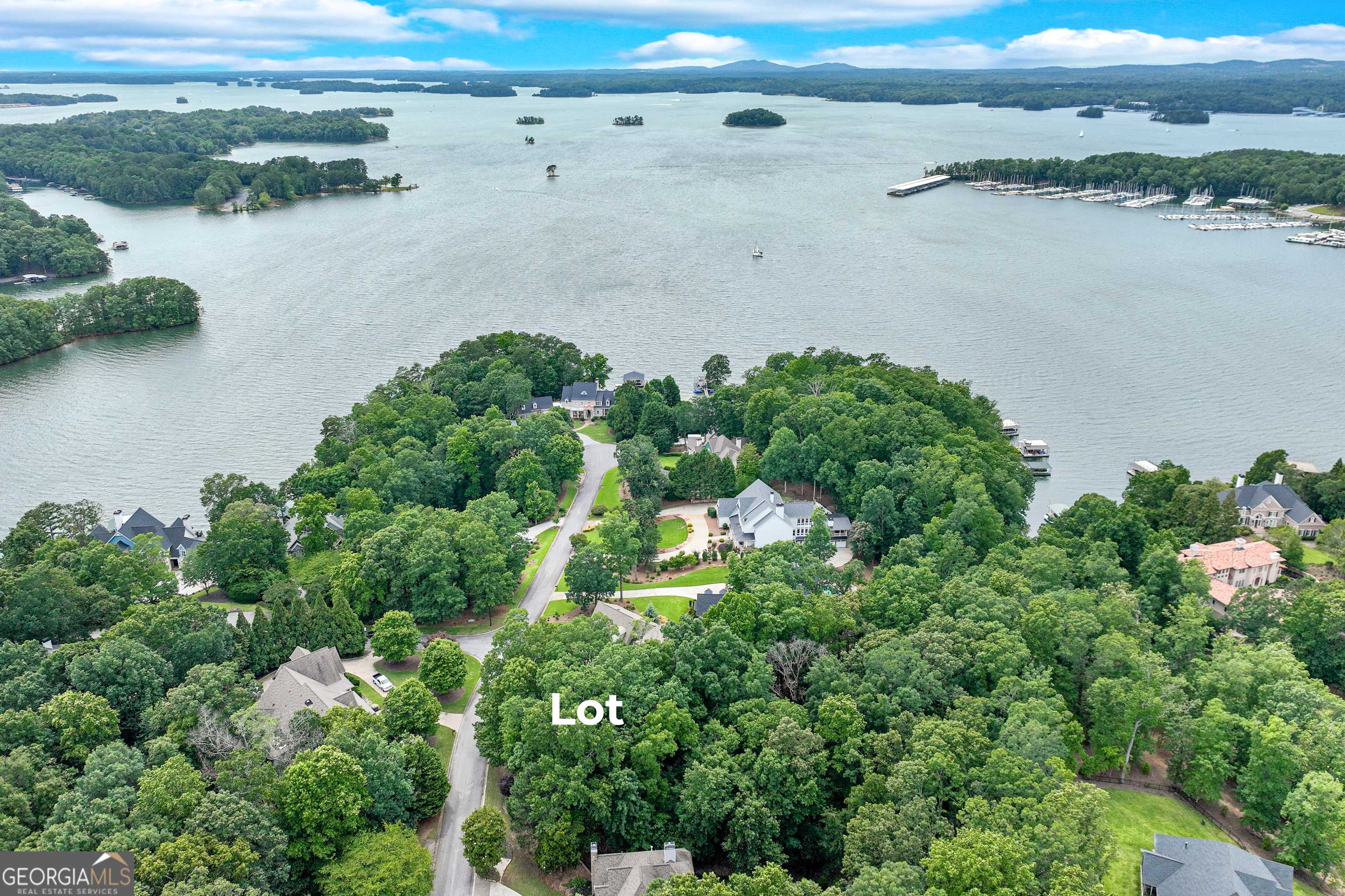 Discover the perfect canvas for your dream home in one of Lake Lanier's most desirable communities-Pointe South - a neighborhood of homes ranging from 1-4 Million. This spectacular .80-acre private lot is one of the last remaining opportunities to build in this prestigious lakeside neighborhood, located on one of the most sought-after streets on the lake. Positioned between 5510 and 5518 Mainsail Way, Lot 18 offers seasonal lake views (possibly more once the lot is cleared for building) a peaceful setting, and a gentle rolling topography-ideal for your custom build of a basement home. The survey and soil tests have already been completed, and a proposed house plan is available to help jump-start your vision. There is not a dock slip nor permit with this property. Imagine waking up to Lake Lanier sunrises and living just minutes from Sunrise Cove Marina, where your boat or watercraft can be ready at a moment's notice. You'll also enjoy convenient access to shopping, dining, and medical care, making this the best of lake living with everyday ease. Secure your spot in one of Lake Lanier's finest communities - Pointe South. Contact us today to walk the lot and explore the possibilities!