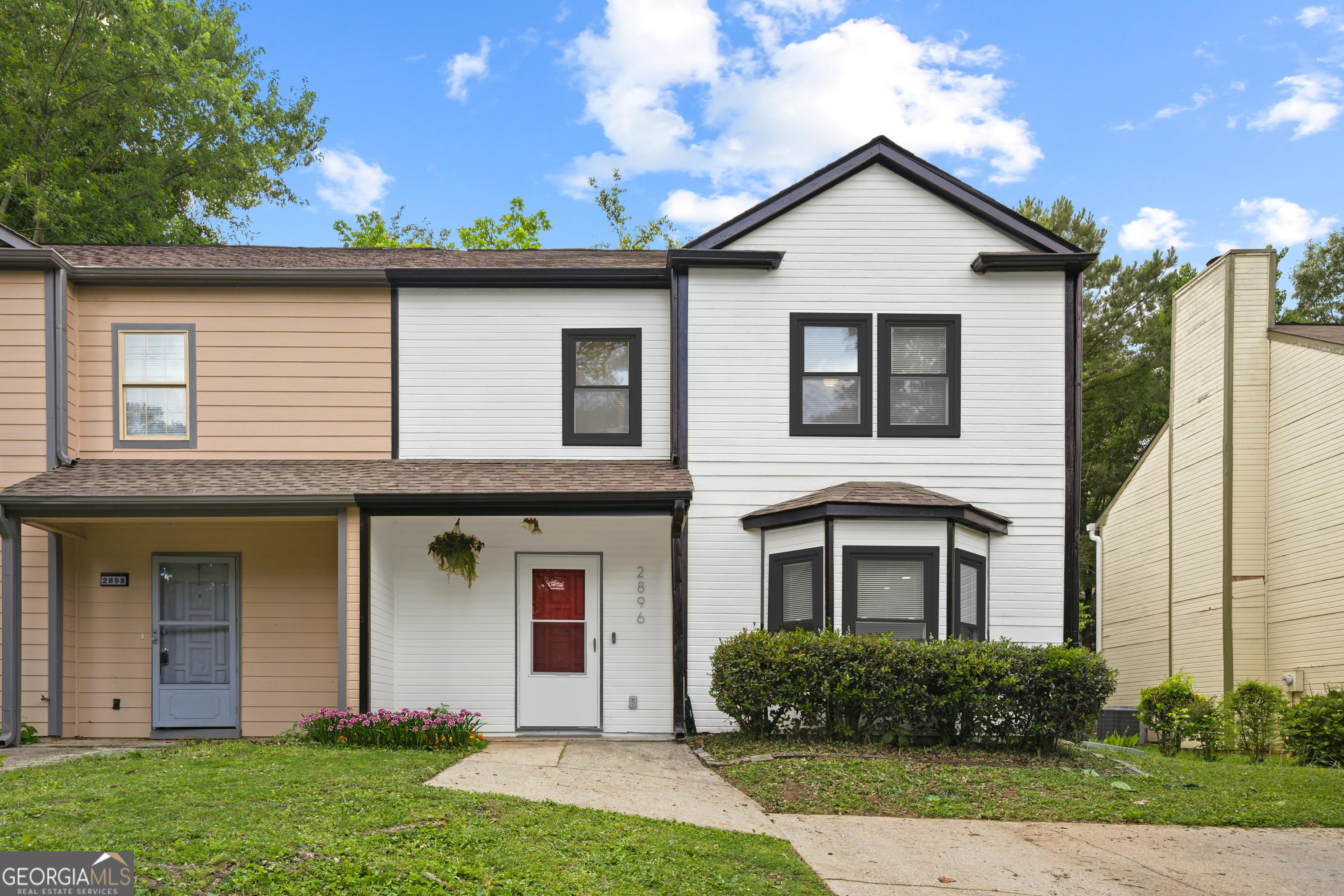 Beautifully Renovated Townhouse - No HOA! Move-in ready and packed with updates, this spacious 3-bedroom, 2.5-bath townhouse in Marietta is a fantastic value! Walk or Bike ride to the new ***MILFORD RECREATION CENTER*** and conveniently located just minutes from The Battery, downtown Smyrna, Marietta Square, Silver Comet Trail, I-75, and I-285. This home offers both comfort and accessibility. Step inside to fresh new paint, flooring, lighting, and a brand-new stove. The updated kitchen flows effortlessly into the family room, where a striking brick fireplace adds warmth and charm. A half bath for guests and a covered rear porch creates the perfect setup for entertaining-ideal for summer barbecues! Upstairs, you'll find three generously sized bedrooms, including a primary en-suite and an extra-large shared bath for the additional bedrooms. With newly renovated bathrooms, a NEW ROOF, ALMOST NEW HVAC, and HOT WATER HEATER, this home is ready for its next owner.