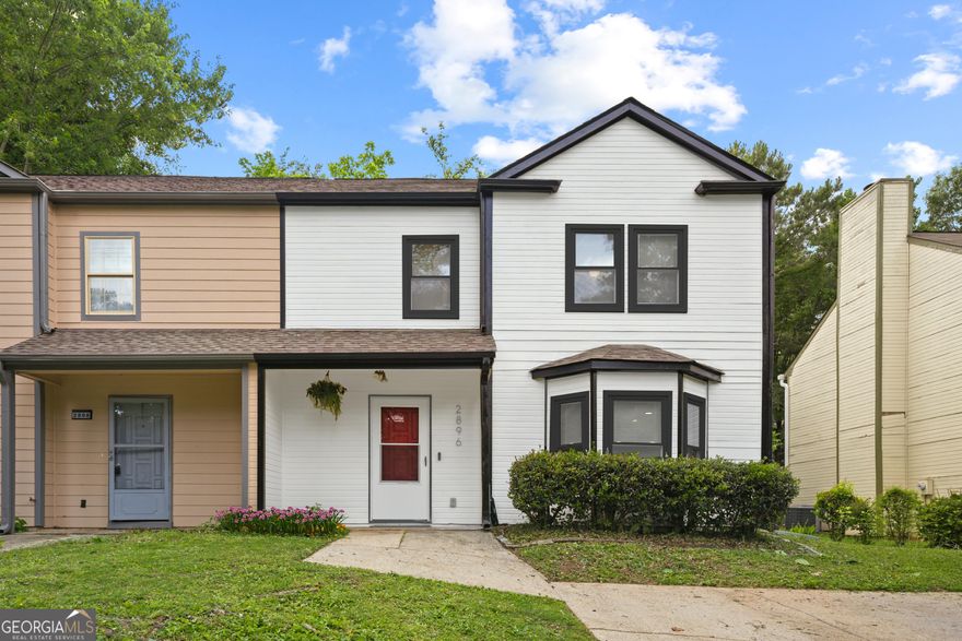 Beautifully Renovated Townhouse - No HOA!   Move-in ready and packed with updates, this spacious 3-bedroom, 2.5-bath townhouse in Marietta is a fantastic value! Walk or Bike ride to the new ***MILFORD RECREATION CENTER*** and conveniently located just minutes from The Battery, downtown Smyrna, Marietta Square, Silver Comet Trail, I-75, and I-285. This home offers both comfort and accessibility.   Step inside to fresh new paint, flooring, lighting, and a brand-new stove. The updated kitchen flows effortlessly into the family room, where a striking brick fireplace adds warmth and charm. A half bath for guests and a covered rear porch creates the perfect setup for entertaining-ideal for summer barbecues!  Upstairs, you'll find three generously sized bedrooms, including a primary en-suite and an extra-large shared bath for the additional bedrooms. With newly renovated bathrooms, a NEW ROOF, ALMOST NEW HVAC, and HOT WATER HEATER, this home is ready for its next owner.